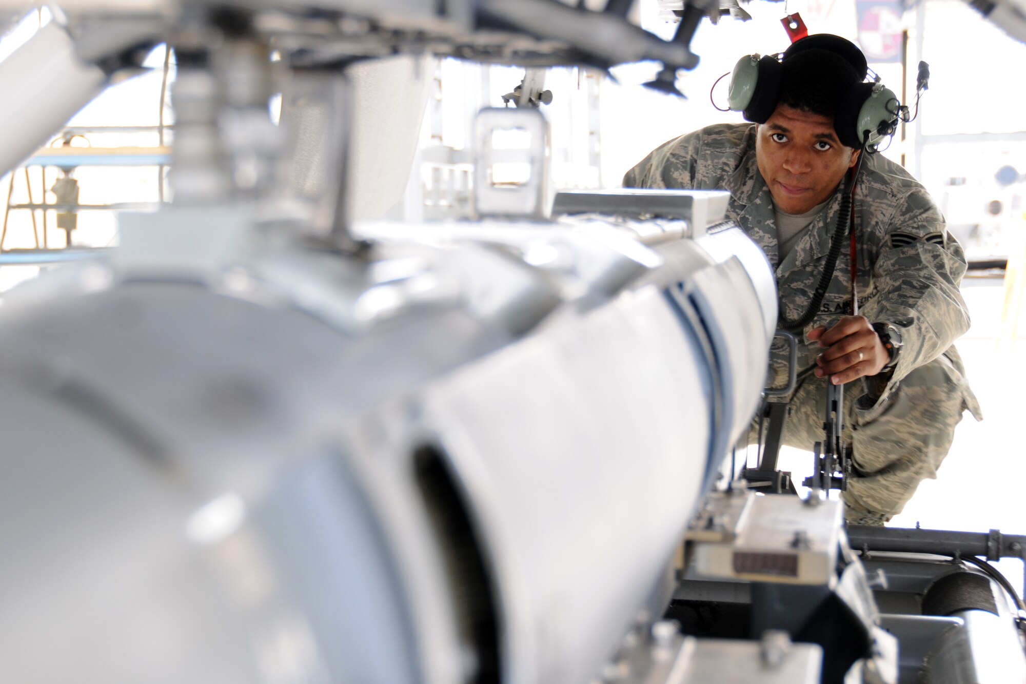 EGLIN AIR FORCE BASE, Fla. – Senior Airman Durral Mason, 16th Electronic Warfare Squadron, lifts an electronic counter measures pod under an F-16 Fighting Falcon. The 16th EWS tests and delivers information that protects today’s warfighters from a multitude of threats. The squadron consists of four flights, a detachment and a cadre of individuals laying the foundation for the next generation of electronic warfare. (U.S. Air Force photo/ Airman 1st Class Anthony Jennings)