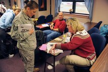 Kim Huskins Webb, library director, shows Tech. Sgt. Andrea Schaub, Airman & Family Readiness Center noncommissioned officer in charge, what the base library is offering as part of the Year of the Air Force Family DePLAYment program during an information fair on Seymour Johnson Air Force Base, N.C., Jan. 22, 2010. The DePLAYment program is open to dependents of Air Force active duty members who deployed between July and December 2009, or returned on or after July 2009.  (U.S. Air Force photo/Tech. Sgt. Lesley Waters)
