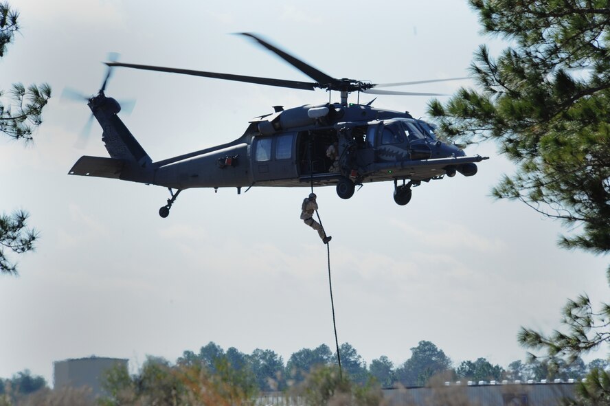 MOODY AIR FORCE BASE, Ga. -- A 38th Rescue Squadron pararescueman repels from a hovering HH-60G Pave Hawk during a mass casualty exercise at Spence Air Field in Moultrie, Ga., Jan. 25. The members of the 38th RQS were flown out to the airfield by the 41st Rescue Squadron. (U.S. Air Force photo by Airman 1st Class Benjamin Wiseman)