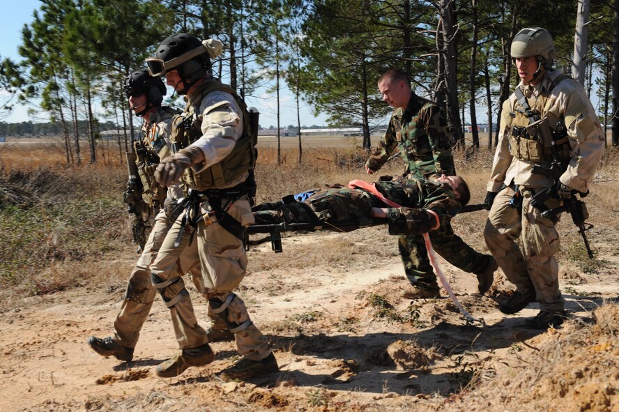 MOODY AIR FORCE BASE, Ga. -- Airmen from the 38th Rescue Squadron evacuate a simulated injured person using a litter during a mass casualty exercise at Spence Air Field in Moultrie, Ga., Jan. 25. Using a litter is a safer way to move severely injured patients because it helps to stabilize the body. (U.S. Air Force photo by Airman 1st Class Benjamin Wiseman)