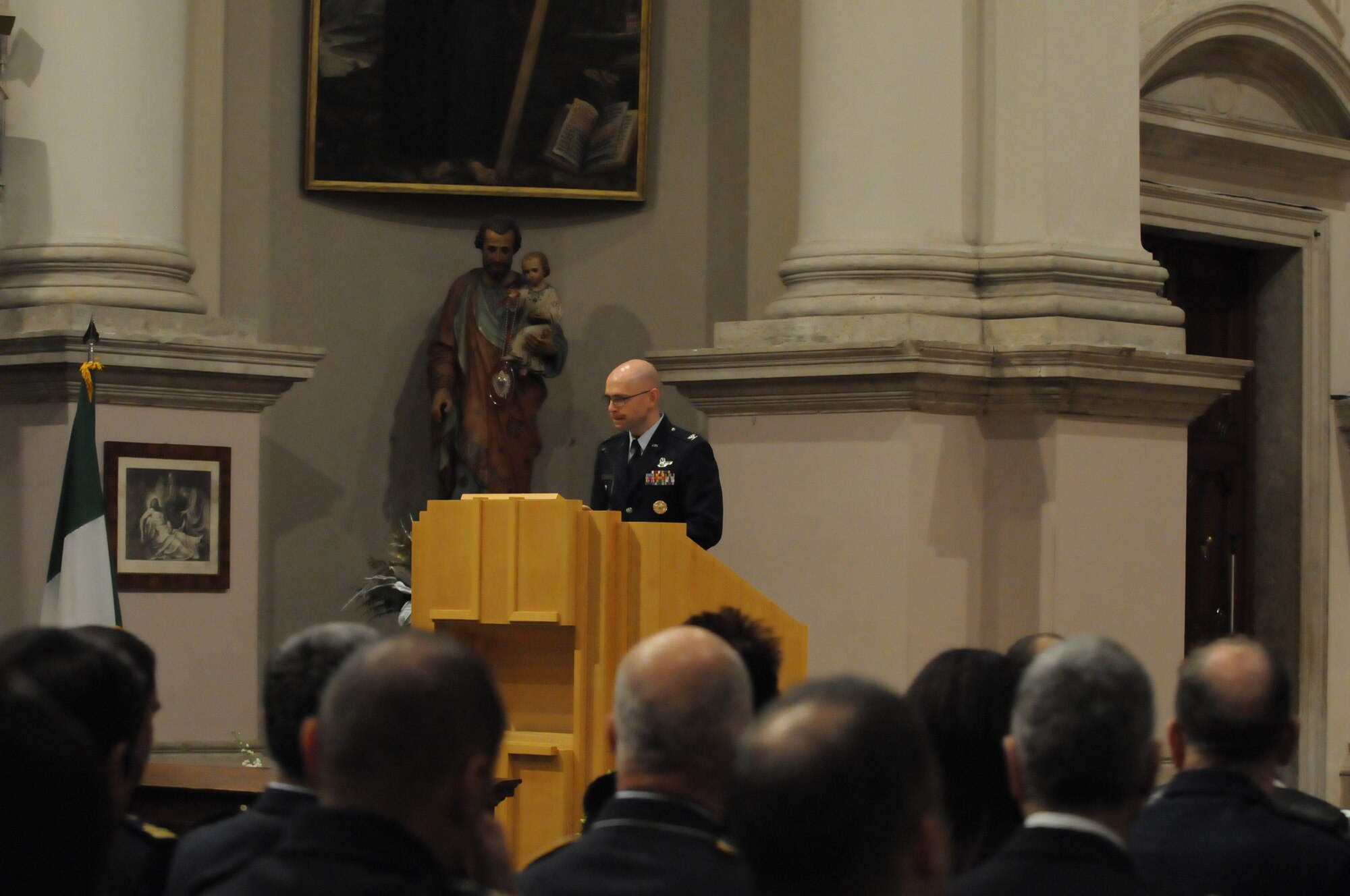 Col. Patrick McClelland, 31st Fighter Wing vice commander, describes the hard working gentle nature of Col. Pone' during a memorial service that was held in Aviano, Italy Jan. 25, 2010. Col. Pone' was assigned to NATO Combined Air Operations Center Five, Poggio Renatico, Italy. The then Lt. Col. Pone', served as the 510th Fighter Squadron's commander and cared about his Airmen. (U.S. Air Force photo/Staff Sgt. Mercedes Crossland)