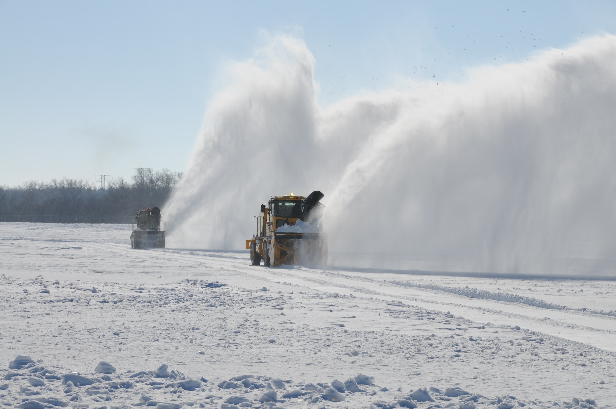 Master Sgt. Kevin Daehling (front) Tech. Sgt Sarah Bredthauer clear the aircraft run-up area of snow at the Nebraska Air National Guard Base on January 13, 2010. Aircraft maintenance members use this area on the west side of the Lincoln Airport runway to do engine runup tests on the 155th Air Refueling Wing's KC-135R Stratotankers. Lincoln, Neb. had a record of over 24 inches of snowfall in December 2009. (Nebraska Air National Guard photo by Senior Master Sgt. Lee Straube)