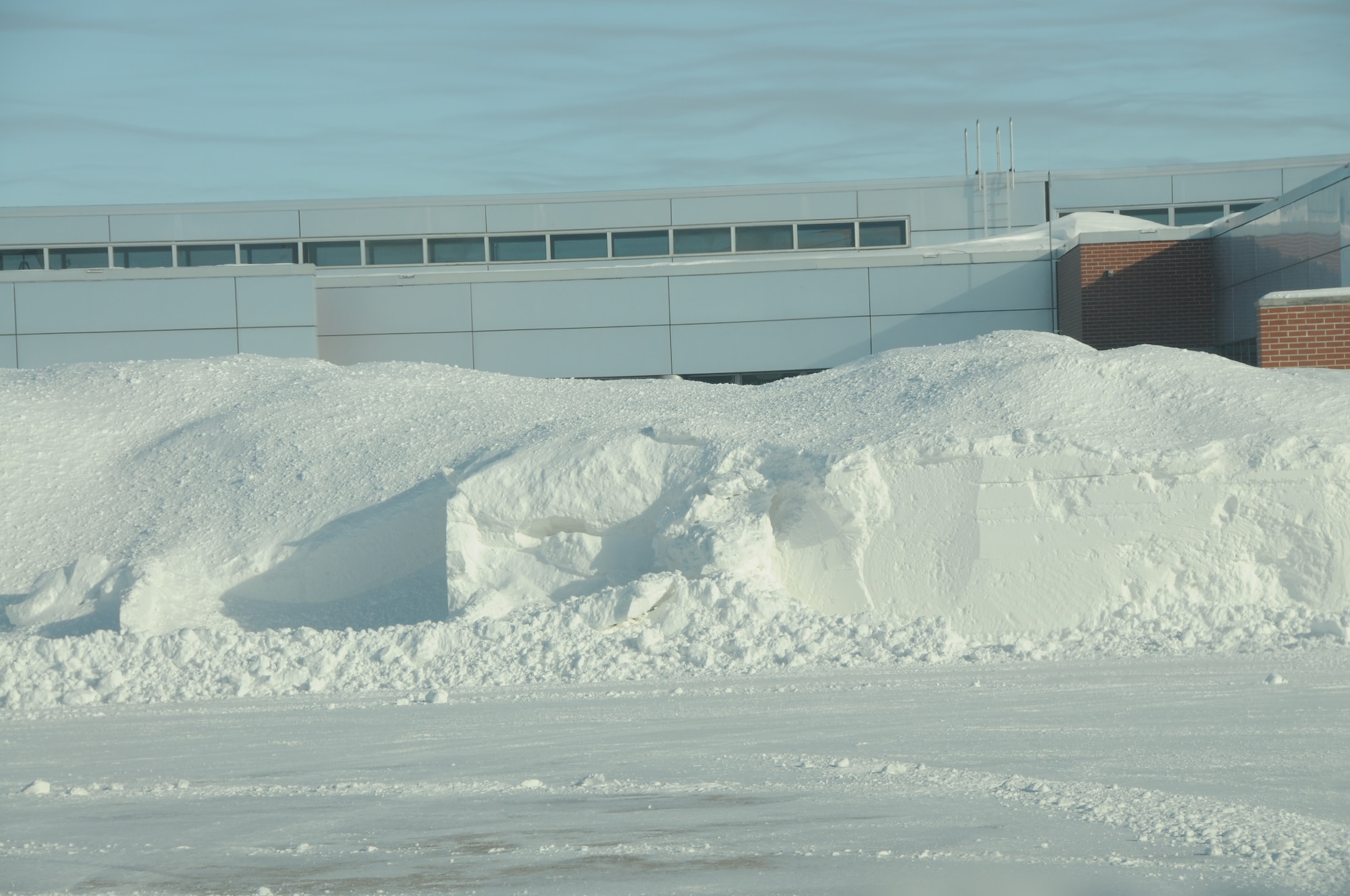 The Operations building sits behind a large pile of snow that drifted and was blown onto a grassy area from the aircraft parking ramp at the Nebraska Air National Guard Base on January 8, 2010. Lincoln, Neb. had a record of over 24 inches of snowfall in December 2009.(Nebraska Air National Guard photo by Senior Master Sgt. Lee Straube)
