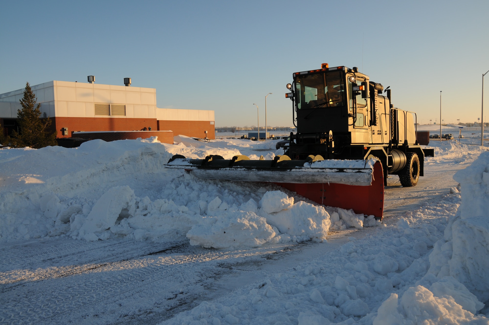 Tech. Sgt. Sarah Bredthauer pushes snow along West Furnas St. at the Nebraska Air National Guard Base on January 13, 2010. Lincoln, Neb. had a record of over 24 inches of snowfall in December 2009.(Nebraska Air National Guard photo by Senior Master Sgt. Lee Straube)