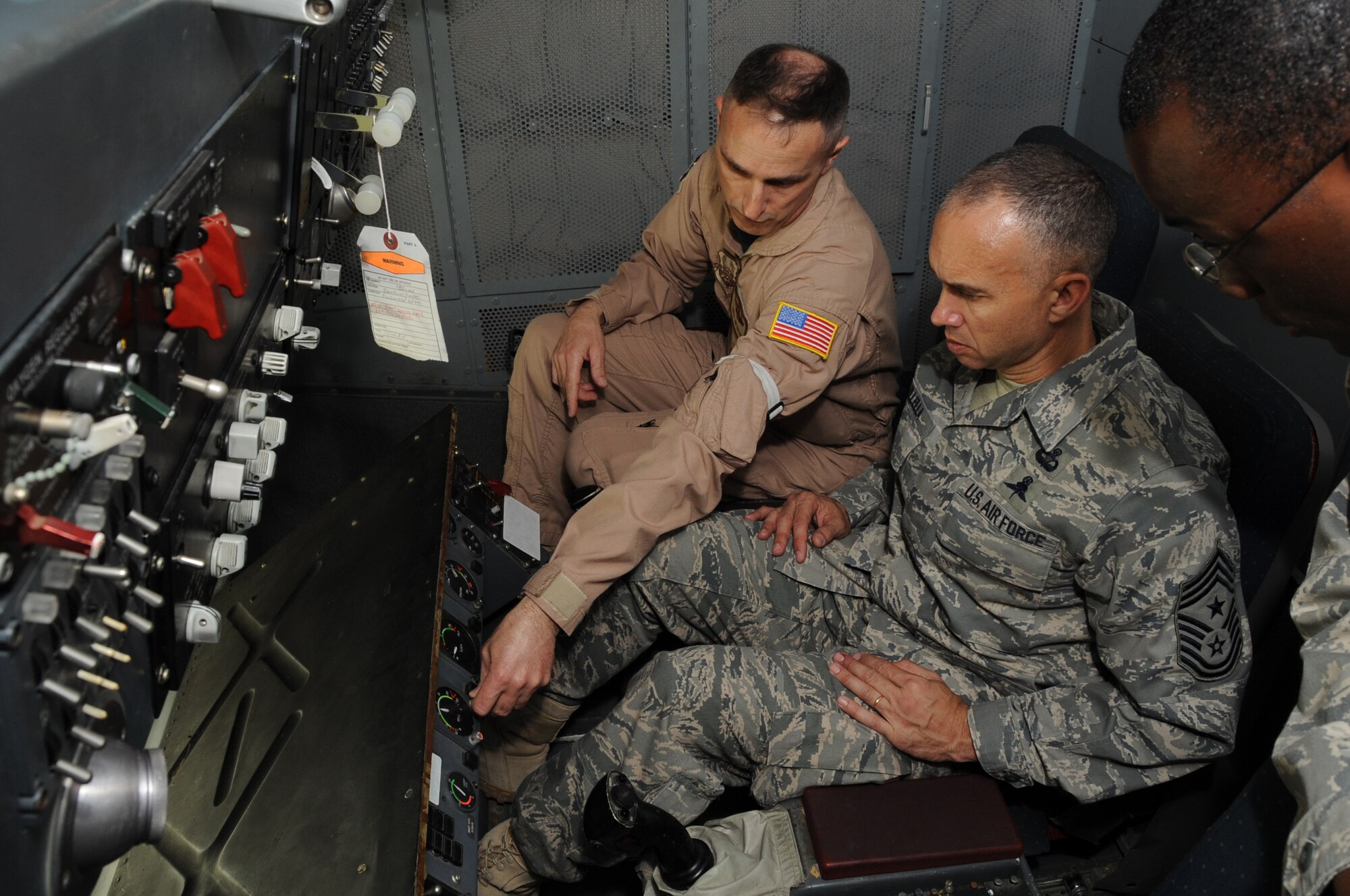 Chief Master Sgt. Ralph Snyder, 380th Expeditionary Operations Group chief enlisted manager, shows Chief Master Sgt. Mark Villella, command chief master sergeant for Air Forces Central Command, the in-flight refueling pod of a KC-10 Extender during Chief Villella's visit to the 380th Air Expeditionary Wing at a non-disclosed base in Southwest Asia on Jan. 6, 2010.  During his visit, Chief Villella learned about the diverse mission of the 380th AEW that includes air refueling, surveillance, and reconnaissance in support of overseas contingency operations in Southwest Asia. The wing supports Operations Iraqi Freedom and Enduring Freedom and the Combined Joint Task Force-Horn of Africa. (U.S. Air Force Photo/Senior Airman Jenifer Calhoun/Released)