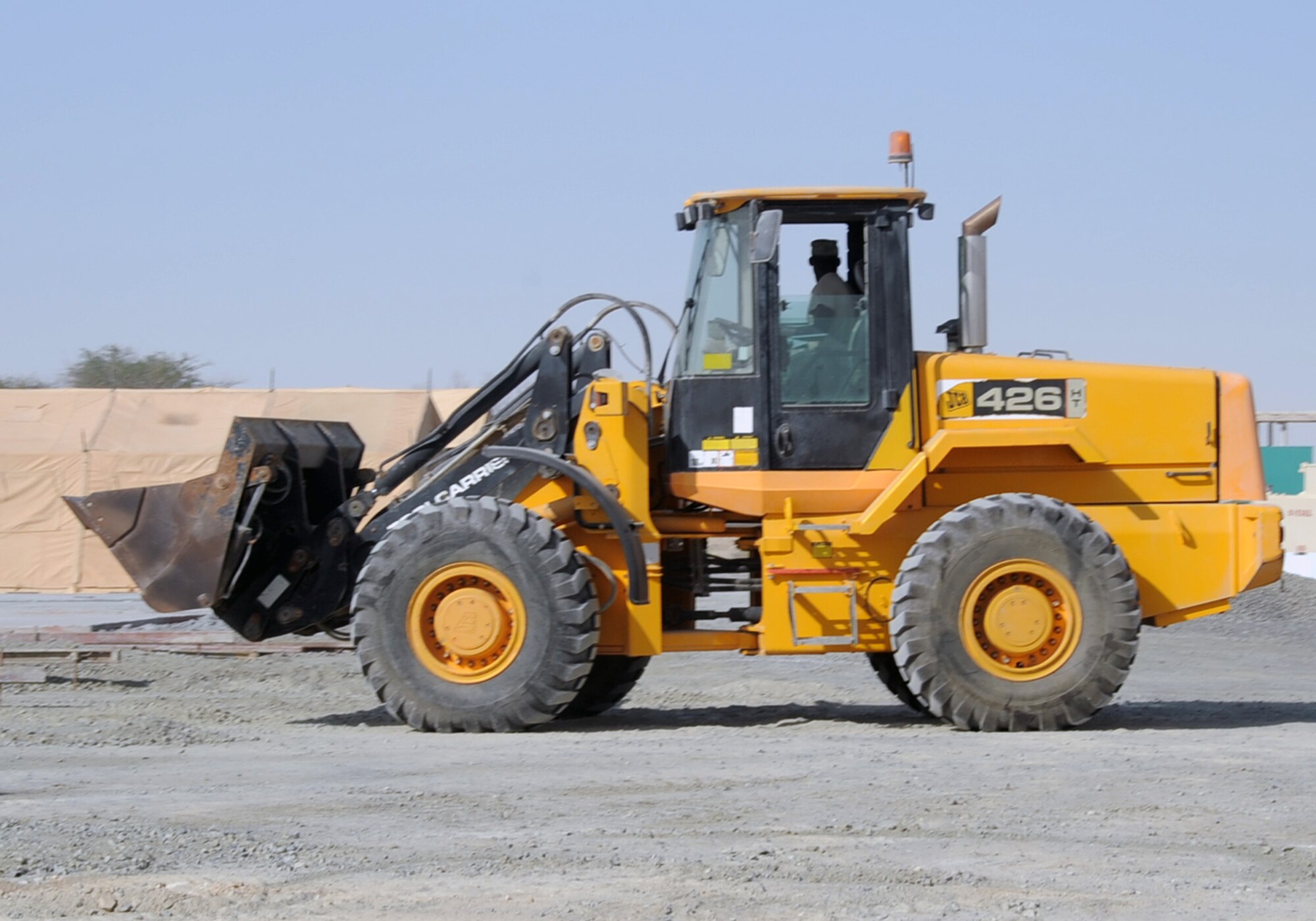 An Airman from the 380th Expeditionary Civil Engineer Squadron uses a front-end loader to move dirt for a project during operations at a non-disclosed base in Southwest Asia on Jan. 26, 2010. The 380th ECES cares for the infrastructure for the 380th Air Expeditionary Wing through work such as this.  The 380th AEW is comprised of four groups and 12 squadrons and the wing's deployed mission includes air refueling, surveillance and reconnaissance in support of overseas contingency operations in Southwest Asia.  The wing supports Operation Iraqi Freedom, Operation Enduring Freedom and the Combined Joint Task Force-Horn of Africa. (U.S. Air Force Photo/Tech. Sgt. Scott T. Sturkol/Released)
