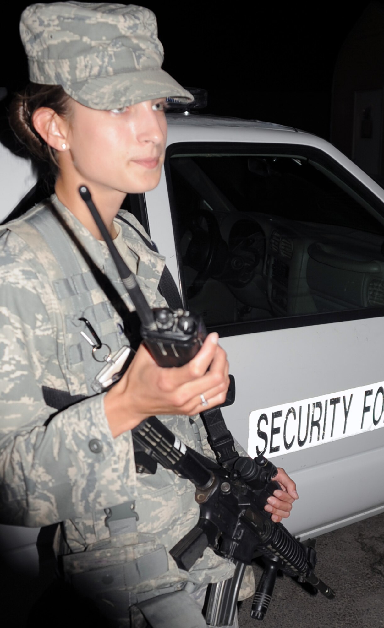 Senior Airman Jaqueline Lawson, security forces journeyman with the 380th Expeditionary Security Forces Squadron, responds to a call over the radio during night shift operations at a non-disclosed base in Southwest Asia on Jan 24, 2010. Airman Lawson is a security forces journeyman charged, along with fellow security forces, with providing security and force protection for the 380th Air Expeditionary Wing, its people and millions of dollars in deployed equipment and assets. Airman Lawson is deployed from the 96th Security Forces Squadron at Eglin Air Force Base, Fla., and her hometown is Middleburg, Fla. (U.S. Air Force Photo/Tech. Sgt. Scott T. Sturkol/Released)