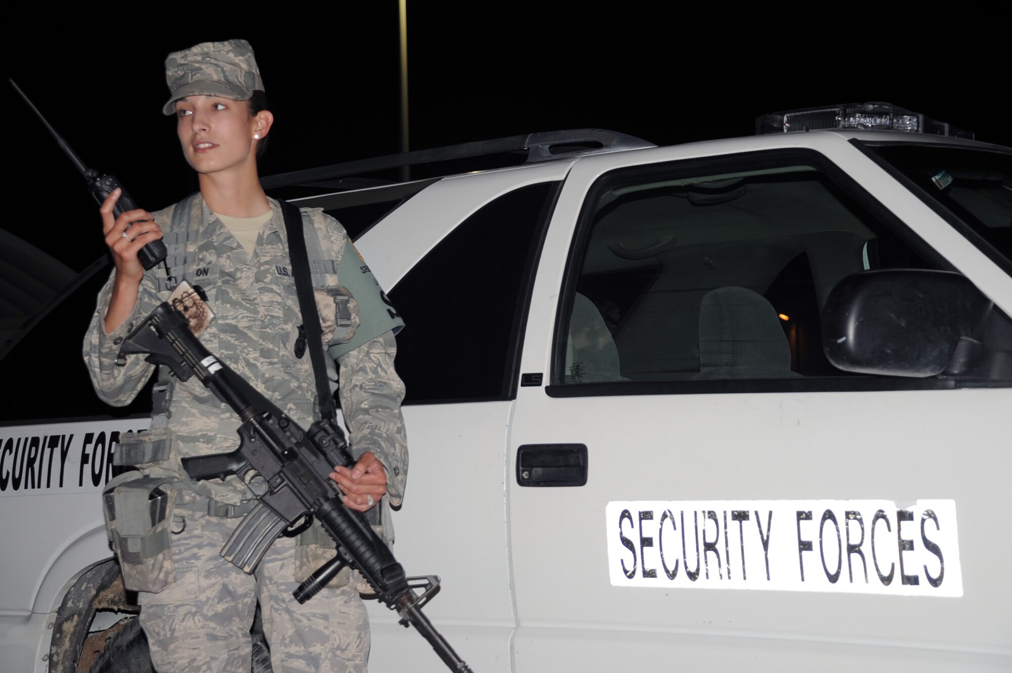 Senior Airman Jaqueline Lawson, security forces journeyman with the 380th Expeditionary Security Forces Squadron, responds to a call over the radio during night shift operations at a non-disclosed base in Southwest Asia on Jan 24, 2010. Airman Lawson is a security forces journeyman charged, along with fellow security forces, with providing security and force protection for the 380th Air Expeditionary Wing, its people and millions of dollars in deployed equipment and assets. Airman Lawson is deployed from the 96th Security Forces Squadron at Eglin Air Force Base, Fla., and her hometown is Middleburg, Fla. (U.S. Air Force Photo/Tech. Sgt. Scott T. Sturkol/Released)