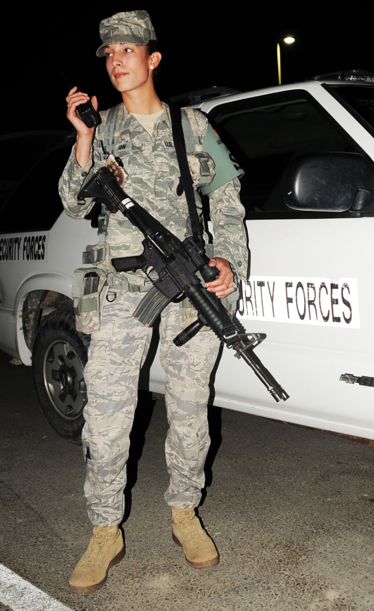 Senior Airman Jaqueline Lawson, security forces journeyman with the 380th Expeditionary Security Forces Squadron, responds to a call over the radio during night shift operations at a non-disclosed base in Southwest Asia on Jan 24, 2010. Airman Lawson is a security forces journeyman charged, along with fellow security forces, with providing security and force protection for the 380th Air Expeditionary Wing, its people and millions of dollars in deployed equipment and assets. Airman Lawson is deployed from the 96th Security Forces Squadron at Eglin Air Force Base, Fla., and her hometown is Middleburg, Fla. (U.S. Air Force Photo/Tech. Sgt. Scott T. Sturkol/Released)