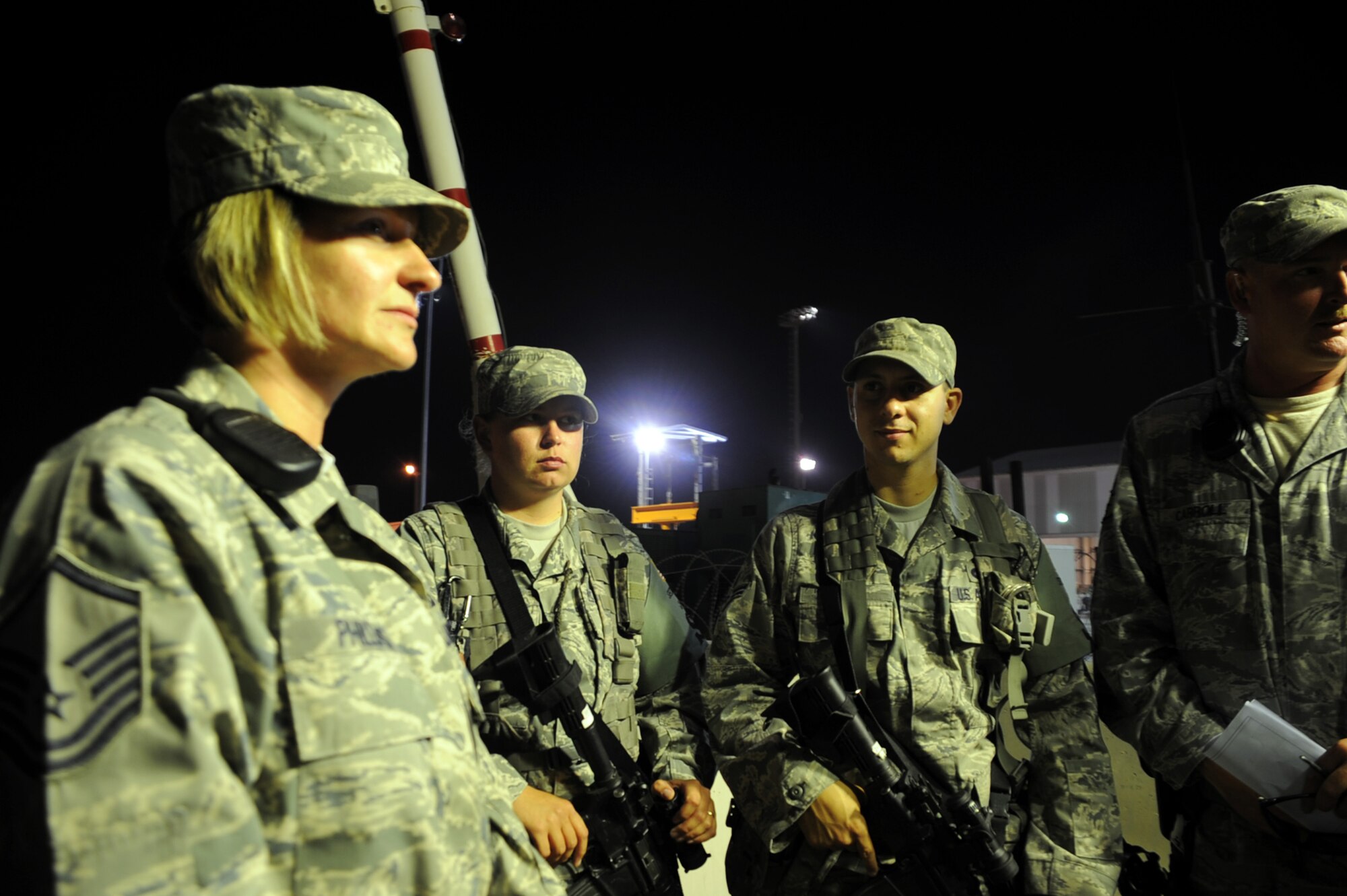 Master Sgt. Lisa Phillips (left), "Alpha" flight chief with the 380th Expeditionary Security Forces Squadron, holds a briefing with security forces Airmen in her flight during a night shift Jan. 24, 2010, at a non-disclosed base in Southwest Asia. The 380th ESFS is in charge of protecting and providing security for millions of dollars of deployed Air Forces assets and nearly 2,000 deployed personnel.  Sergeant Phillips is a 16-year Air Force veteran deployed from the 81st Security Forces Squadron at Keesler Air Force Base, Miss.  Her hometown is Lombard, Ill.  (U.S. Air Force Photo/Tech. Sgt. Scott T. Sturkol/Released)