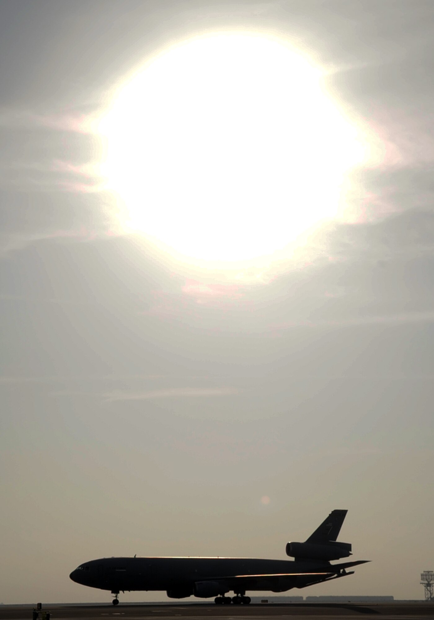 A pilot guides a KC-10 Extender as it returns from a a combat air refueling mission during operations on the flightline at a non-disclosed base in Southwest Asia on Jan. 23, 2009. The KC-10, assigned to the 908th Expeditionary Air Refueling Squadron from Joint Base McGuire-Dix-Lakehurst, N.J., is one of Air Mobility Command's air refueling aircraft deployed to the U.S. Central Command area of responsibility that provides the "global reach" for Air Force and Department of Defense aircraft through air refueling operations for Operations Iraqi Freedom and Enduring Freedom and the Combined Joint Task Force-Horn of Africa. (U.S. Air Force Photo/Tech. Sgt. Scott T. Sturkol/Released)