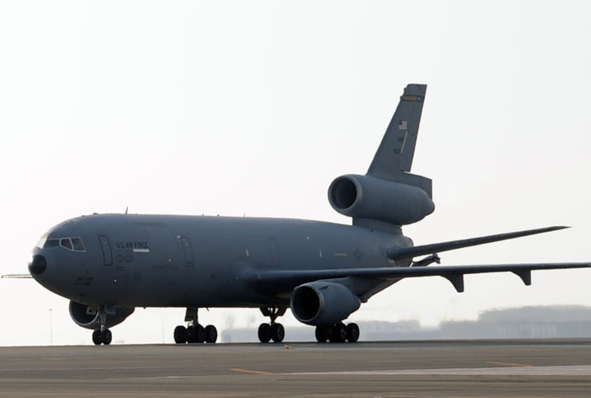 A pilot guides a KC-10 Extender as it returns from a a combat air refueling mission during operations on the flightline at a non-disclosed base in Southwest Asia on Jan. 23, 2009. The KC-10, assigned to the 908th Expeditionary Air Refueling Squadron from Joint Base McGuire-Dix-Lakehurst, N.J., is one of Air Mobility Command's air refueling aircraft deployed to the U.S. Central Command area of responsibility that provides the "global reach" for Air Force and Department of Defense aircraft through air refueling operations for Operations Iraqi Freedom and Enduring Freedom and the Combined Joint Task Force-Horn of Africa. (U.S. Air Force Photo/Tech. Sgt. Scott T. Sturkol/Released)