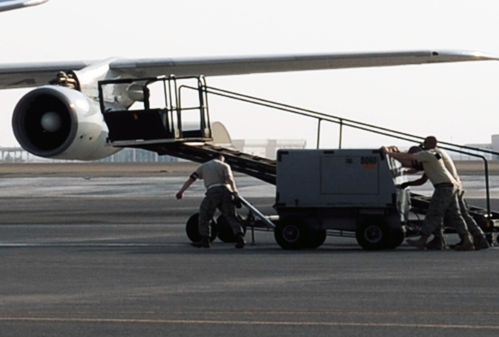 Maintenance Airmen work on an E-3 Sentry Airborne Warning and Control System aircraft during operations on the flightline at a non-disclosed base in Southwest Asia on Jan. 23, 2010.  The E-3, assigned with the 965th Airborne Air Control Squadron of the 380th Air Expeditionary Wing, is a modified Boeing 707/320 commercial airframe with a rotating radar dome that provides situational awareness of friendly, neutral and hostile activity, command and control of an area of responsibility, battle management of theater forces, all-altitude and all-weather surveillance of the battle space, and early warning of enemy actions during joint, allied, and coalition operations. (U.S. Air Force Photo/Tech. Sgt. Scott T. Sturkol/Released)