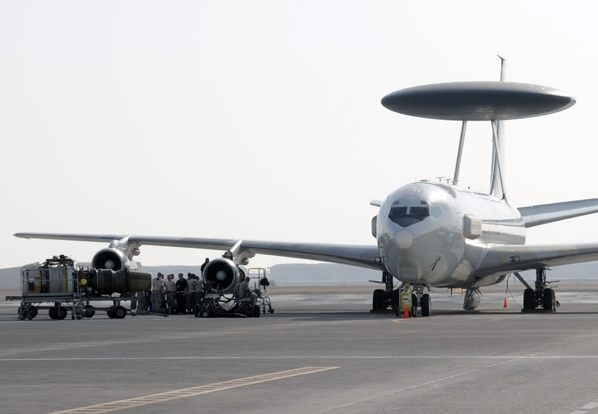 Maintenance Airmen work on an E-3 Sentry Airborne Warning and Control System aircraft during operations on the flightline at a non-disclosed base in Southwest Asia on Jan. 23, 2010.  The E-3, assigned with the 965th Airborne Air Control Squadron of the 380th Air Expeditionary Wing, is a modified Boeing 707/320 commercial airframe with a rotating radar dome that provides situational awareness of friendly, neutral and hostile activity, command and control of an area of responsibility, battle management of theater forces, all-altitude and all-weather surveillance of the battle space, and early warning of enemy actions during joint, allied, and coalition operations. (U.S. Air Force Photo/Tech. Sgt. Scott T. Sturkol/Released)