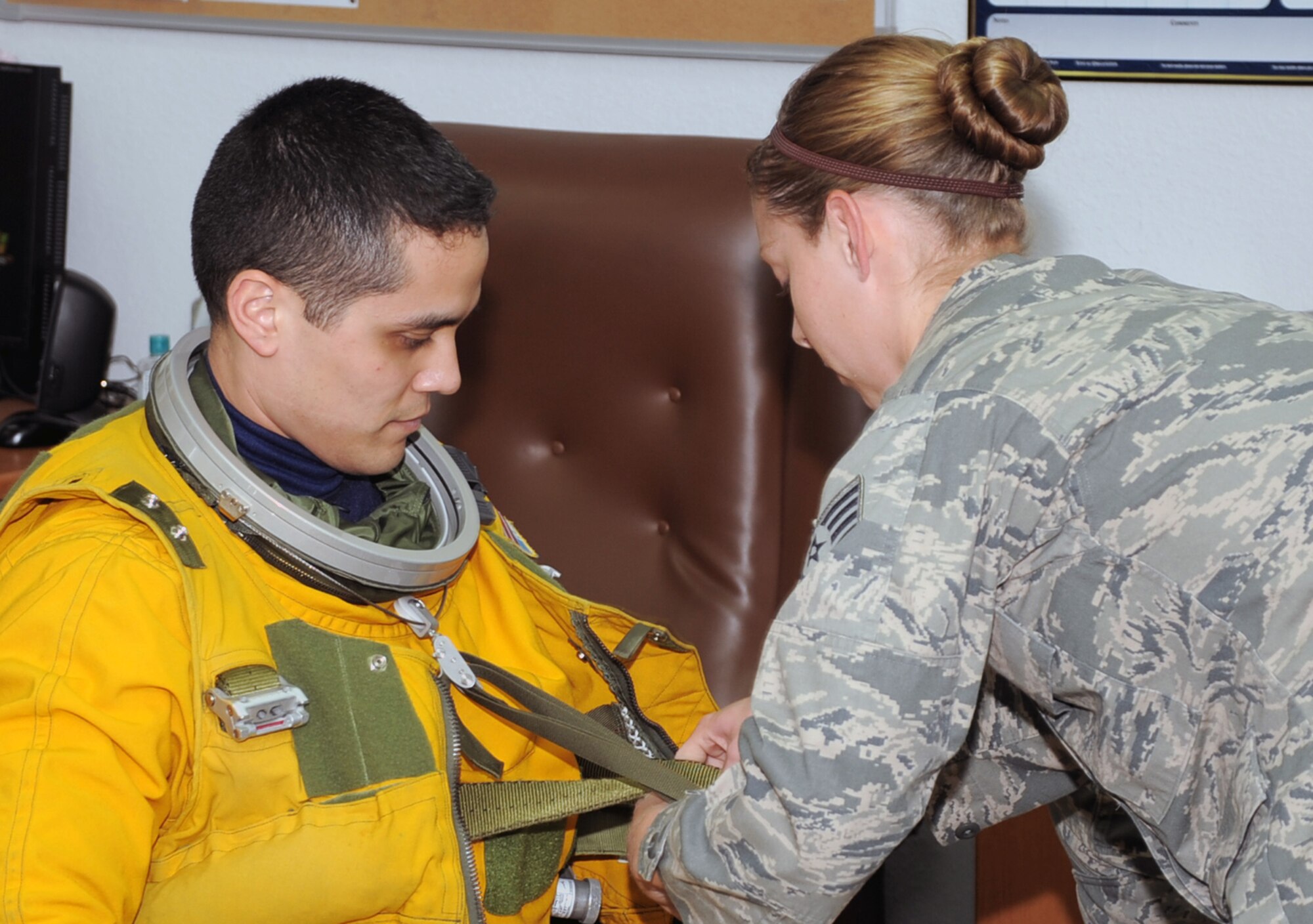 Staff Sgt. Lynnette Keeton, aerospace physiologist with the 99th Expeditionary Reconnaissance Squadron, help gear up Capt. Tony Aponte, U-2 Dragon Lady pilot, before Captain Aponte was to go on a mission on Jan. 23, 2010, at a non-disclosed location in Southwest Asia.  Because the U-2 flies as high an altitude as 70,000 feet, pilots are required to wear a special suit to complete their mission.  The 99th ERS, part of the 380th Air Expeditionary Wing, supports Operations Iraqi Freedom and Enduring Freedom and the Combined Joint Task Force-Horn of Africa. (U.S. Air Force Photo/Tech. Sgt. Scott T. Sturkol/Released)