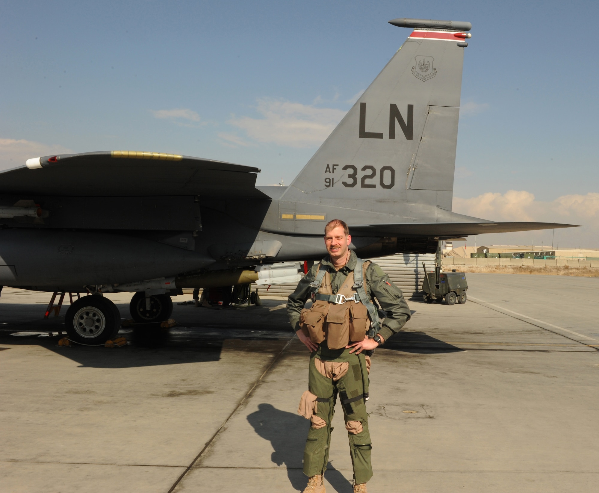 BAGRAM AIRFIELD, Afghanistan--U.S. Air Force Lt. Col. John Bunnell, 494th Expeditionary Fighter Squadron commander, stands below tail "320" after completing his 3,000th flight hour in the F-15E Strike Eagle Jan. 24, 2010. Bunnell is a weapons system officer from Birmingham, Ala., and is deployed from the 48th Fighter Wing, Royal Air Force Lakenheath, England. (U.S. Air Force photo by/Staff Sgt. Richard Williams)