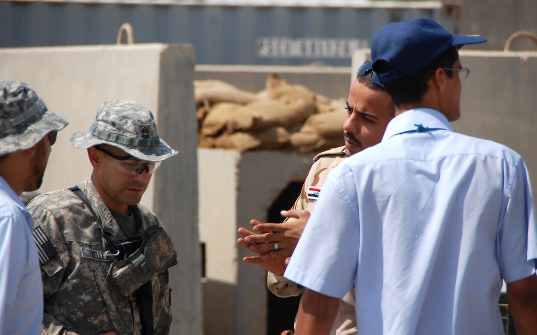 Army Sgt. 1st Class Jason Tellez discusses convoy procedures with an Iraqi soldier at Contingency Operating Base Adder, Iraq. U.S. Army photo by Spc. Marcos DelValle