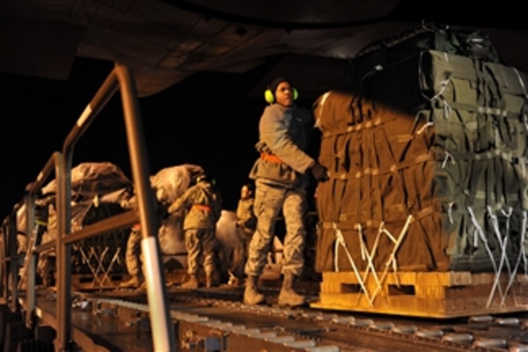 U.S. Air Force airmen load container delivery system bundles of food and water onto a C-130 Hercules aircraft at Pope Air Force Base, Fayetteville, N.C., before being flown to Haiti as part of an air delivery mission to Haiti in support of Operation Unified Response on Jan. 22, 2010.  This is the first time a two-ship formation of C-130 Hercules crews air-deliver food and water during the operation.  U.S. Southern Command is deploying assets to Haiti to conduct search and rescue operations, damage assessments and transitions to prevent human suffering and additional deaths.  