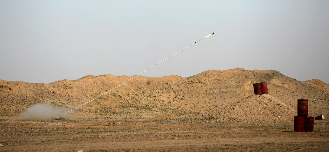 A line of obstacle-breeching explosives is launched by Weapons Company Marines to clear a route at a military range here Jan. 27 during a bilateral training exercise conducted by Kuwaitis and the 11th Marine Expeditionary Unit.