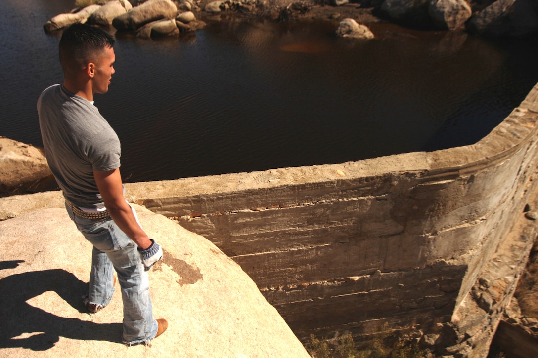 Seaman Apprentice Charles Haskell, a religious program specialist with 3rd Combat Engineer Battalion, marvels over a dam at Keys Ranch in Joshua Tree National Park Jan. 28. Ranch visits are only available by appointment Saturdays and Sundays during park ranger-guided tours at 10 a.m. and 1 p.m. from October through May. Weekday scheduling varies and can be checked at the website, http://www.nps.gov/jotr/planyourvisit/programs.html.