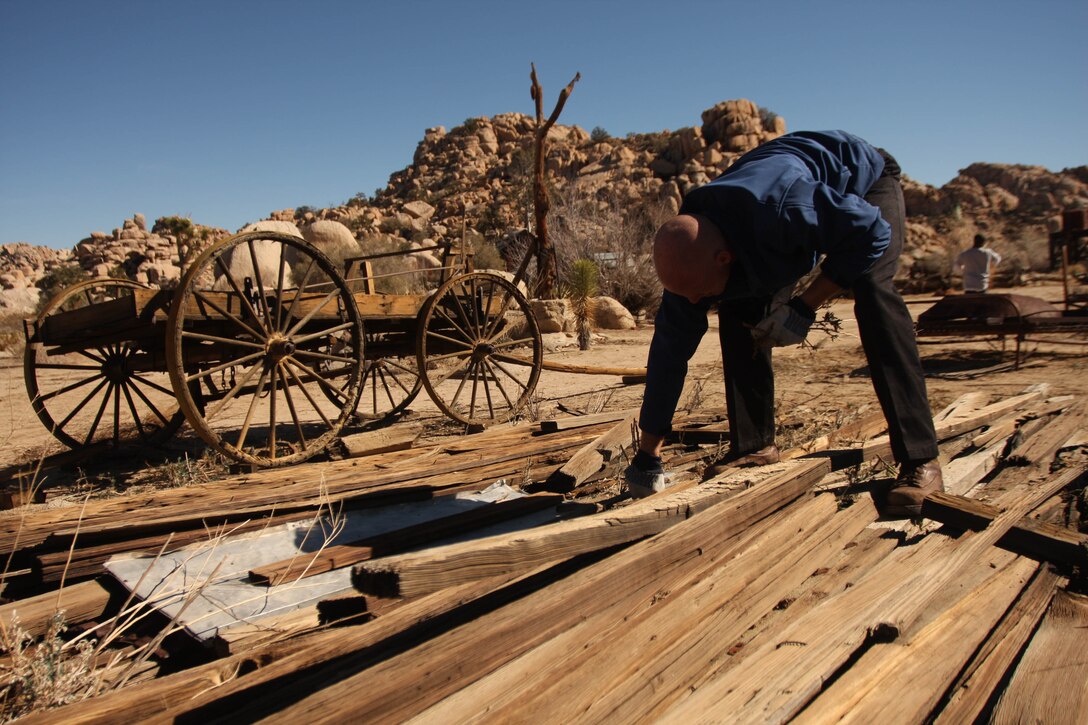 Navy Lt. Bryan Davenport, the chaplain of 3rd Combat Engineer Battalion, makes his way through a pile of wood, removing any unwanted vegetation at Keys Ranch in Joshua Tree National Park Jan 28. Ranch visits are only available by appointment Saturdays and Sundays during park ranger-guided tours at 10 a.m. and 1 p.m. from October through May. Weekday scheduling varies and can be checked at the website, http://www.nps.gov/jotr/planyourvisit/programs.html.