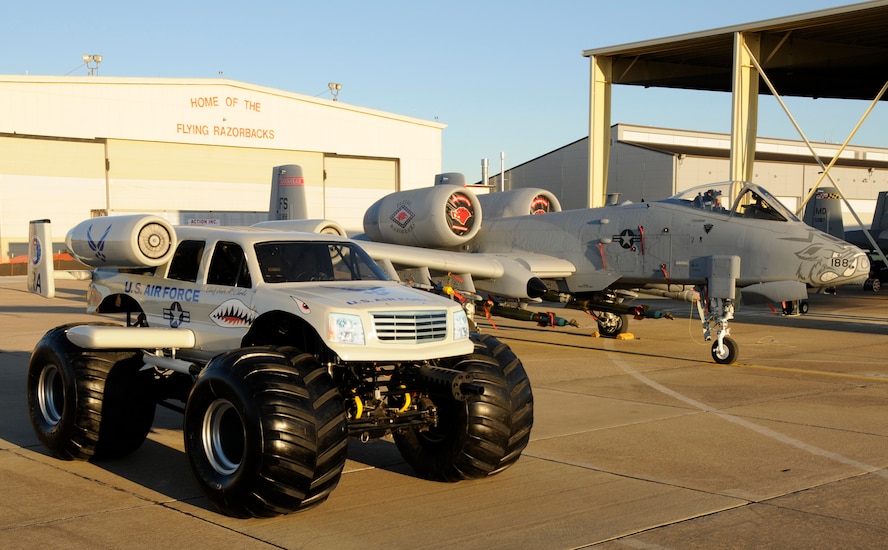 An A-10 monster truck is positioned next to an A-10C Thunderbolt II "Warthog" at the 188th Fighter Wing in Fort Smith, Ark., during a photo and video shoot with U.S. Air Force Recruiting Services Jan. 26, 2010. (U.S. Air Force photo by Capt. Heath Allen/188th Fighter Wing Public Affairs)
