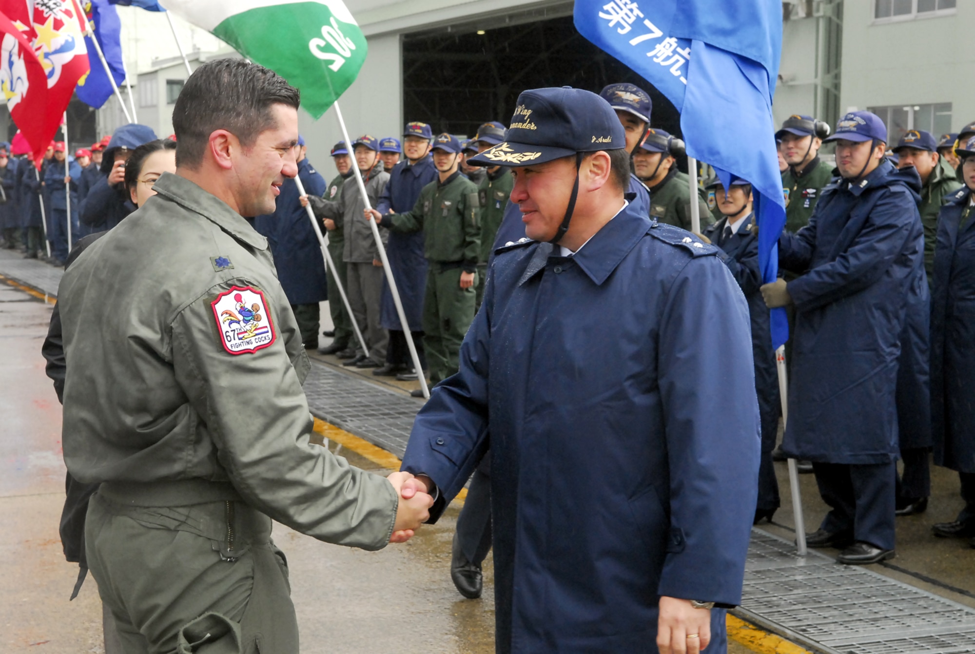 Lt. Col. James Sukenik, 67th Fighter Squadron director of operations, greets Japan Air Self Defense Force Maj. Gen. Junihi Araki, 7th Wing commander at Hyakuri Air Base after arriving Jan. 29. Airmen and F-15Cs from Kadena are operating from the base, which sits about 70 miles north of Tokyo, as part of an aviation training relocation. The Airmen will spend the next eight days flying alongside and with their Japanese counterparts. (U.S. Air Force photo / 1st Lt. Bryan Bouchard)