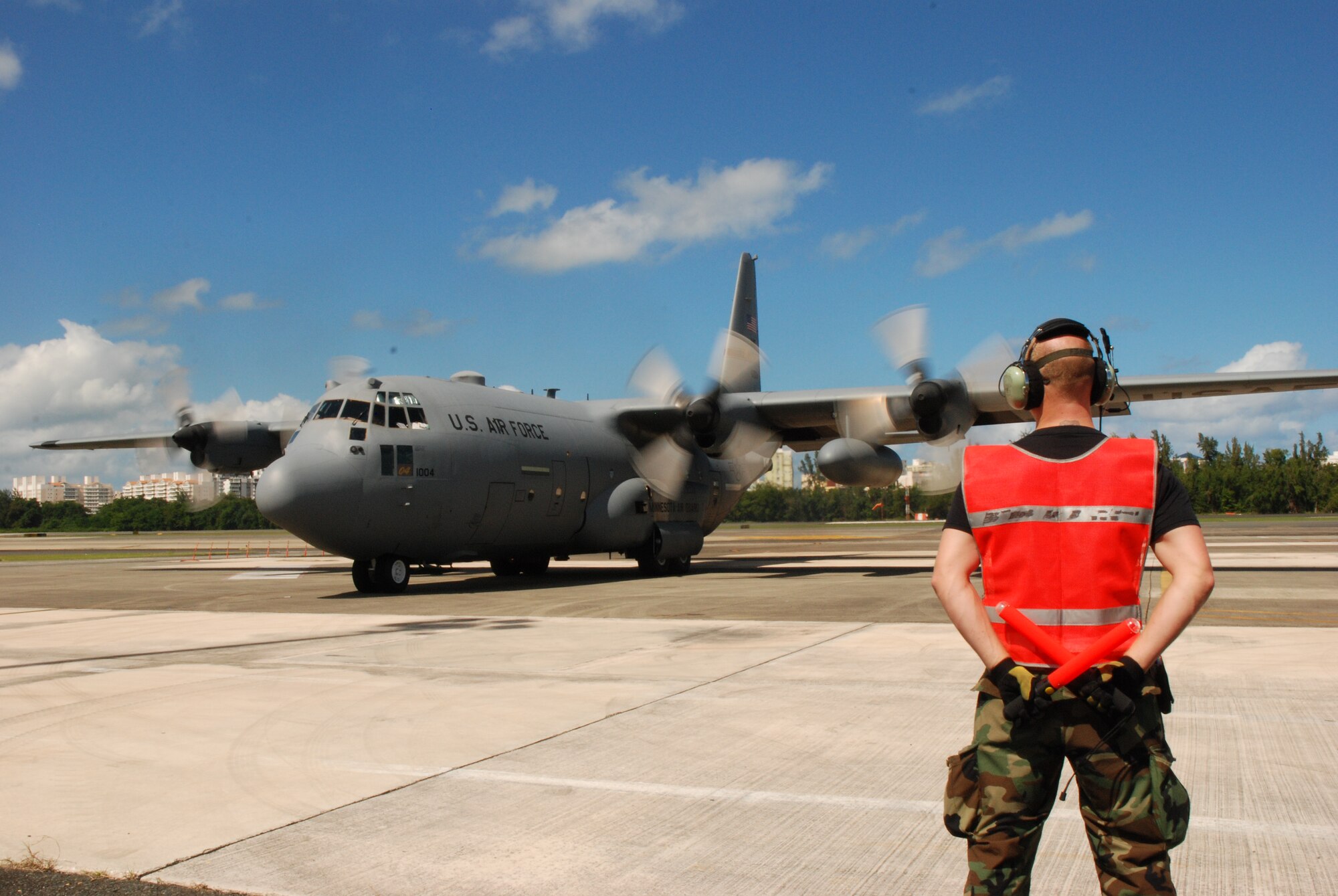 Tech. Sgt. Leon Peterson, 35th Expeditionary Airlift Squadron propulsion technician, assigned from the 133rd Airlift Wing, St. Paul, Minn., stands ready and waiting to marshal out a C-130 in support of Operation Unified Response.  (U.S. Air Force photo/Master Sgt. Stan Coleman)