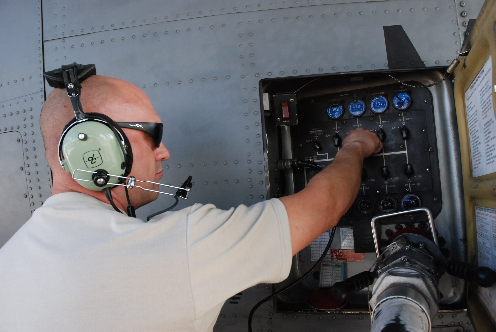 Tech. Sgt. Brad Dahl, 35th Expeditionary Airlift Squadron crew chief, assigned from Minnesota Air National Guard's 133rd Airlift Wing, fuels a C-130 in preparation for an airlift mission supporting Operation Unified Response. (U.S. Air Force photo/Master Sgt. Stan Coleman)  

