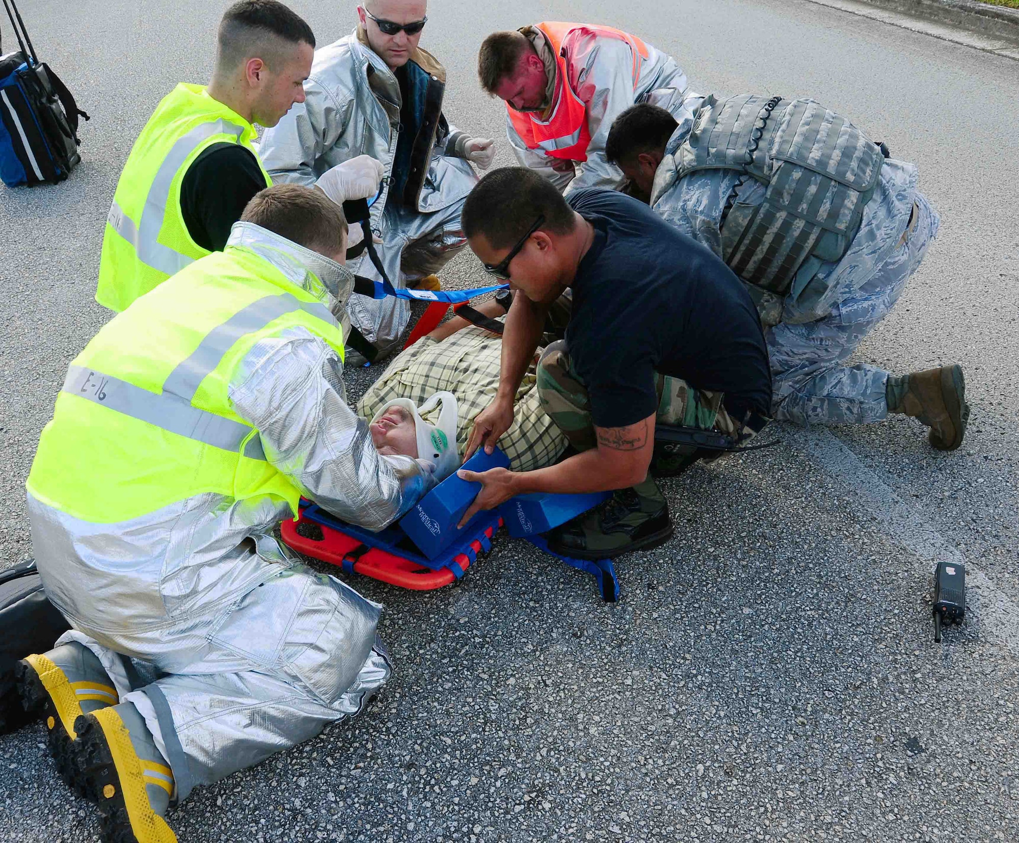 ANDERSEN AIR FORCE BASE, Guam - Members of the Andersen Air Force Base Fire and Emergency Services Team and the 36th Security Forces Squadron respond to a car accident scenario during the operational readiness exercise Jan. 25.. The first responders took action in response to different contingencies throughout the exercise.(U.S. Air Force photo by Airman 1st Class Jeffrey Schultze)