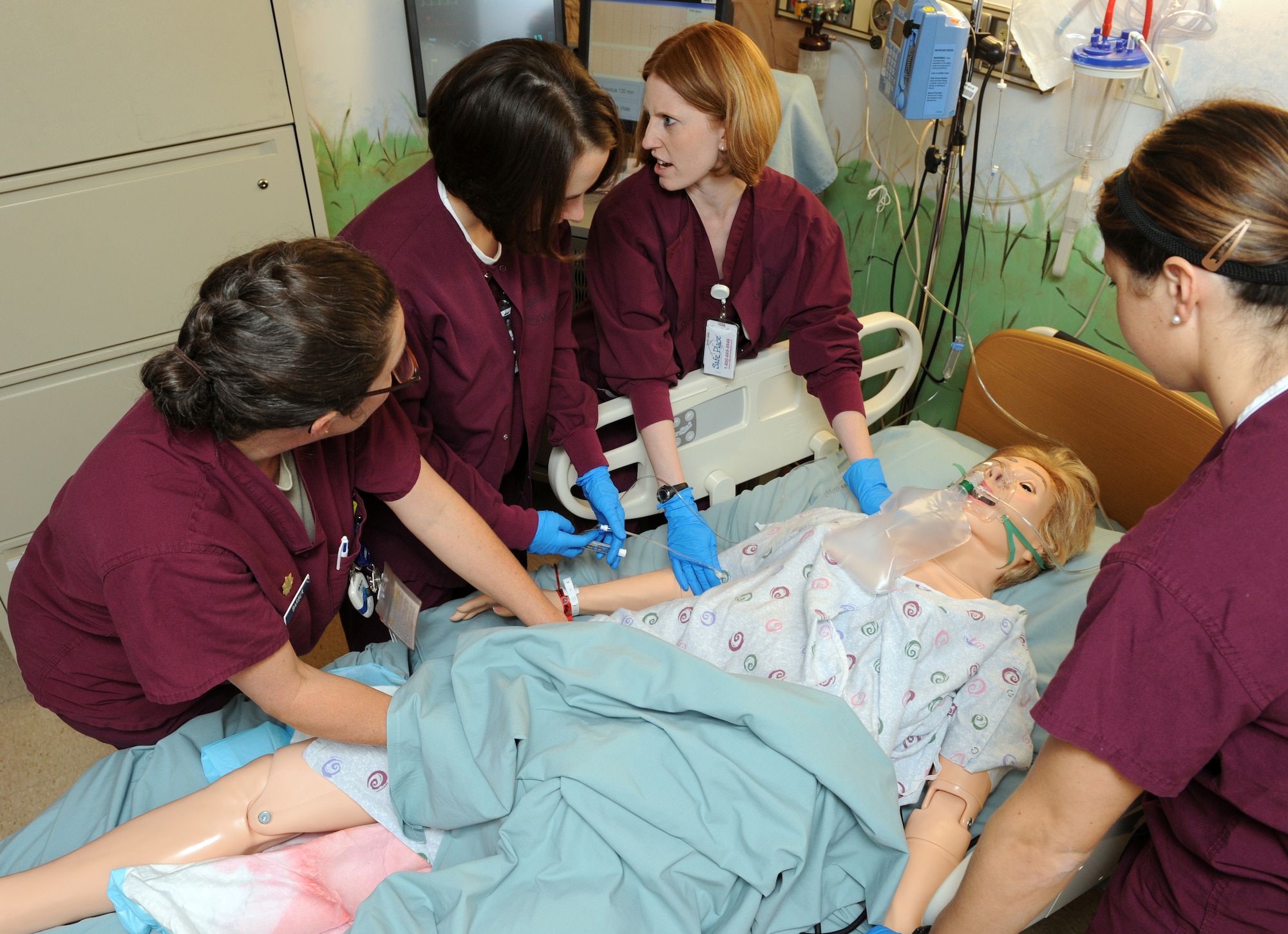 MOUNTAIN HOME AIR FORCE BASE, Idaho -- A medical team from the 366th Medical Surgical Squadron family care unit, simulates stabilizing a pregnant woman Jan. 25. The 366th Medical Group has a new obstetrics emergency simulator, which is used to simulate a variety of rare, but life threatening scenarios. It has computer controlled vital signs, pulses and can bleed and seize which allows medical staff to practice the skills needed in emergency situations. (U.S. Air Force photo by Airman 1st Class Debbie Lockhart)

