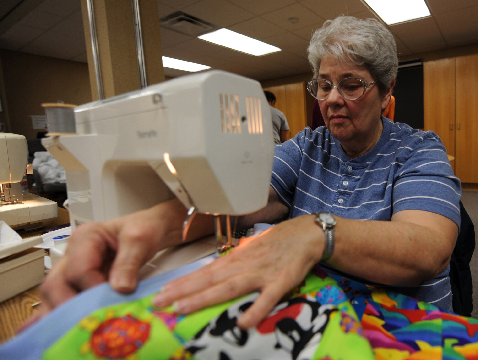 MOUNTAIN HOME AIR FORCE BASE, Idaho -- Jean Clark sews together quilt patterns during Hammond Quilt Day at the 366th Force Support Squadron Airman and Family Readiness Center Jan. 23. Volunteers assembled approximately 40 crocheted blankets, hats and cards into individual bundles to donate to families with newborn babies. (U.S. Air Force photo by Airman 1st Class Renishia Richardson)