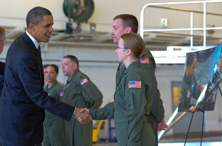 President Barack Obama shakes the hand of Air Force Senior Airman Brooke Lohr Jan. 28 at MacDill Air Force Base, Fla. President Obama and Vice President Joe Biden briefly met with Airmen providing aeromedical evacuation support to victims of the recent earthquake in Port-au-Prince, Haiti. Airman Lohr is a cardiopulmonary technician deployed from the 88th Medical Group at Wright-Patterson Air Force Base, Ohio. She and fellow critical care air transport team member, Capt. Jeffery Marsh (second from right), were among the Airmen thanked by the President for their direct support to Operation Unified Response. (U.S. Air Force photo/Staff Sgt. Joseph Swafford) 