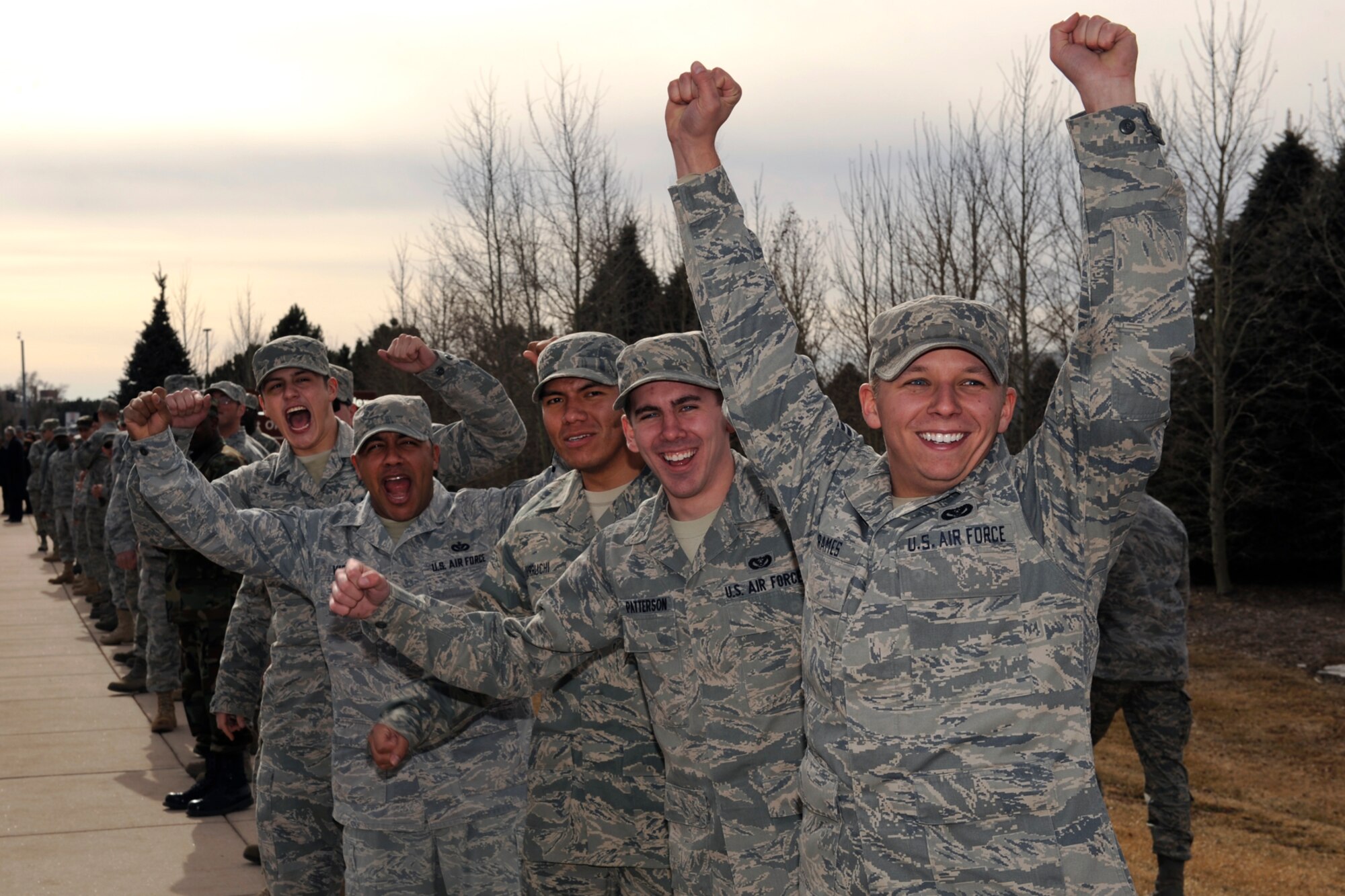 Peterson Airmen greet the LeMay evaluation team Jan. 21 at the North Gate with wild enthusiasm. The six-member team spent two days examining the 21st Force Support Squadron programs and facilities. The 21st FSS is one of four finalists for the Curtis E. LeMay Award, given annually to the best service organization. The winner is expected to be announced in March. (Air Force photo by Craig Denton)