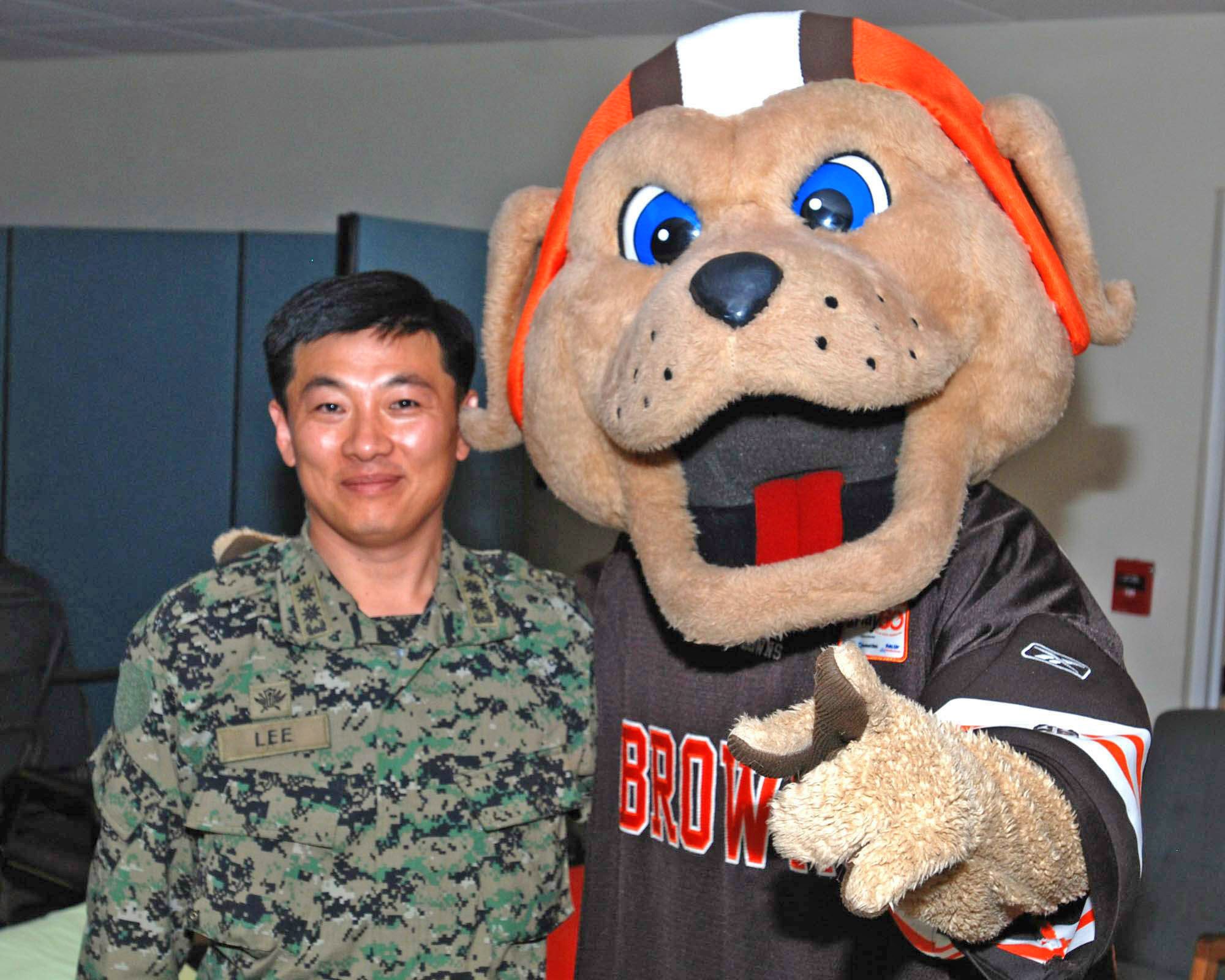The Cleveland Browns' mascot poses with South Korean Army Lt. Col. Chang Lee Jan. 27, 2010, at Homestead Air Reserve Base, Fla. Colonel Chang, South Korea Army liaison officer to the U.S. Strategic Command, is an advance officer for a 250-person element of South Korean engineers who are deploying to Haiti to help reconstruct the island's infrastructure. (U.S. Air Force photo/Tech. Sgt. Brian Bahret)