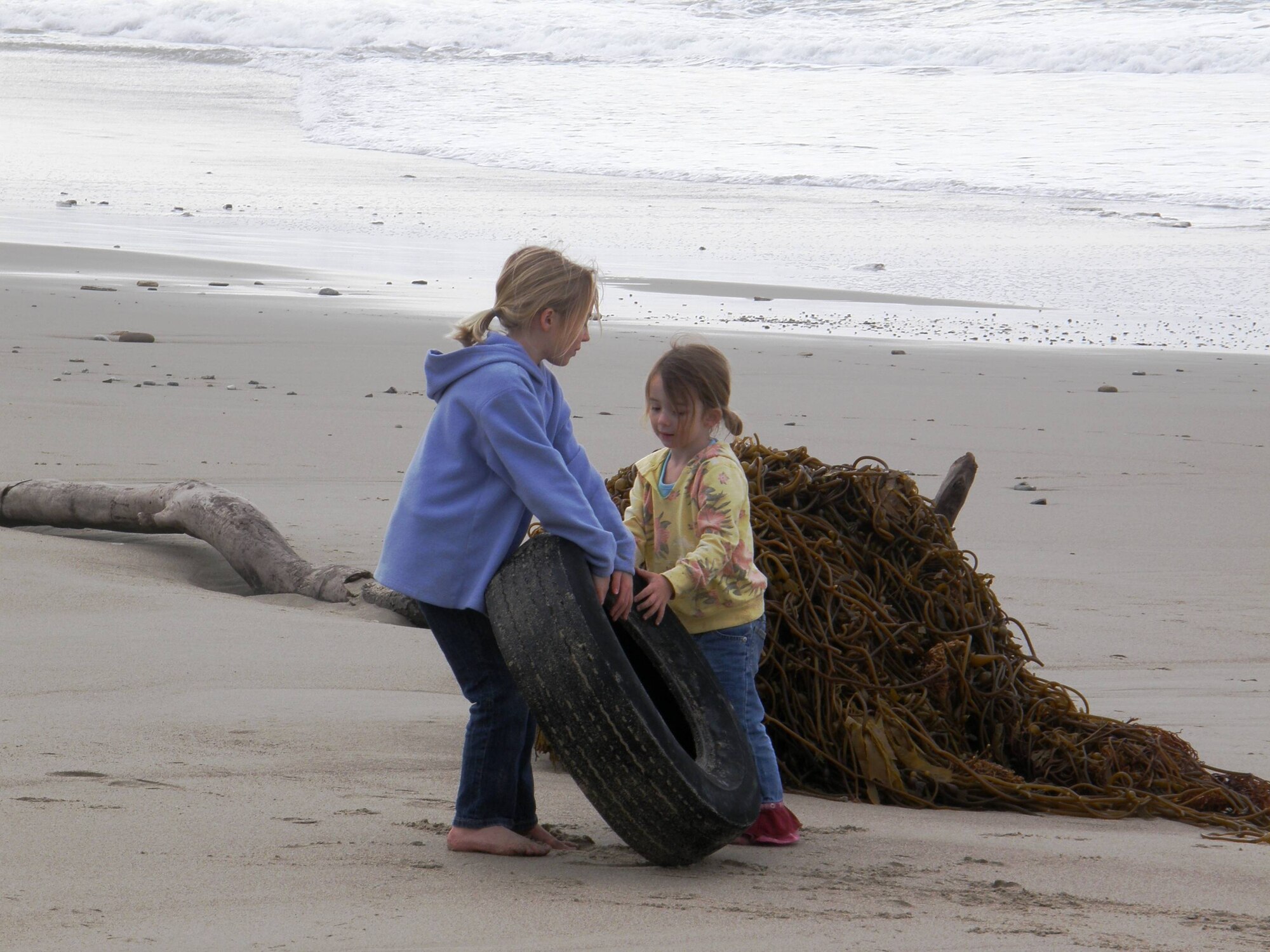 VANDENBERG AIR FORCE BASE, Calif. – Working together as a team, Bailey Stricker and Braedyn Stricker, of the Vandenberg Home-school Inclusive Partnership, help clean-up Wall Beach here Monday, Jan. 28, 2010. The team of Vandenberg home-schoolers removed trash and nine tires from the beach. (Courtesy photo/Vandenberg Home-school Inclusive Partnership)