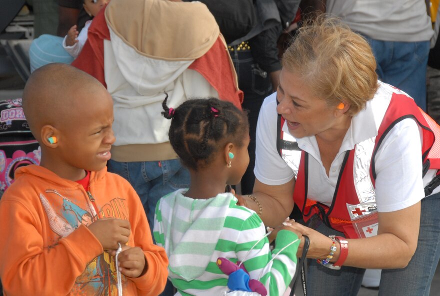 American Red Cross personnel attempt to comfort children evacuated from the aftermath of the earthquake that hit Haiti are boarding a Minnesota Air Guard C-130 aircraft at the Puerto Rico Air National from where they will be airlifted to Homestead AFB as part of Operation Unified Response. Both Puerto Rico and Minnesota Air National Guard are providing support under the command for US SOUTHCOM, 35th Expeditionary Airlift Squadron. (United States Air Force photo by Master Sgt. Anthony Hall)