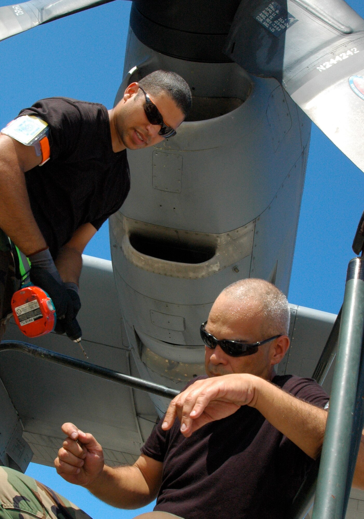 Senior Airman Richard Amador (left) and Staff Sgt. Victor Flores, C-130 Hercules sheet metal technicians assigned to the Puerto Rico Air National Guard's 156th Airlift Wing, troubleshoot an engine cover issue Jan. 24 at Muniz Air Base, Puerto Rico. Both technicians toiled over the issue several times until the Minnesota ANG aircraft's engine air intake cover was securely fastened back to the aircraft. The aircraft is from one of two airlift wings deployed to Muniz Air Base in support of Air Expeditionary Force Coronet Oak, operated by the 35th Expeditionary Airlift Squadron. (U.S. Air Force photo/Staff Sgt. Stephen J. Collier)