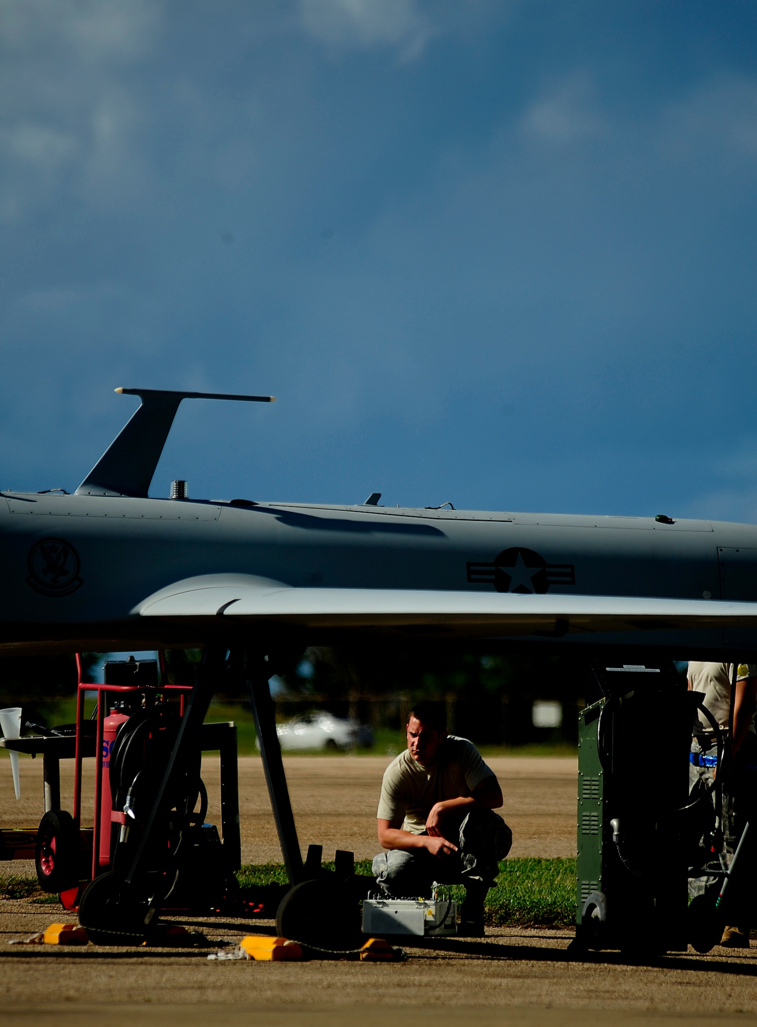 U.S. Air Force from the 432nd Aircraft Maintenance Sq., Creech Air Force Base, Nevada conducts pre-flight maintenance on an RQ-1 Predator at Aeropuerto Rafael Hernandez outside Aguadilla, Puerto Rico on 28 Jan., 2010.  The RQ-1 remotely piloted systems are operating out of Puerto Rico in support of Operation Unified Response in Haiti.  Airmen from Creech Air Force Base, Las Vegas, Nev. are providing 24 hour a day full-motion video in real time to international relief workers on the ground in order to speed humanitarian aid to remote and cut-off areas of the country following the earthquake on 12 Jan., 2010. (U.S. Air Force photo by Tech. Sgt. James L. Harper Jr.)