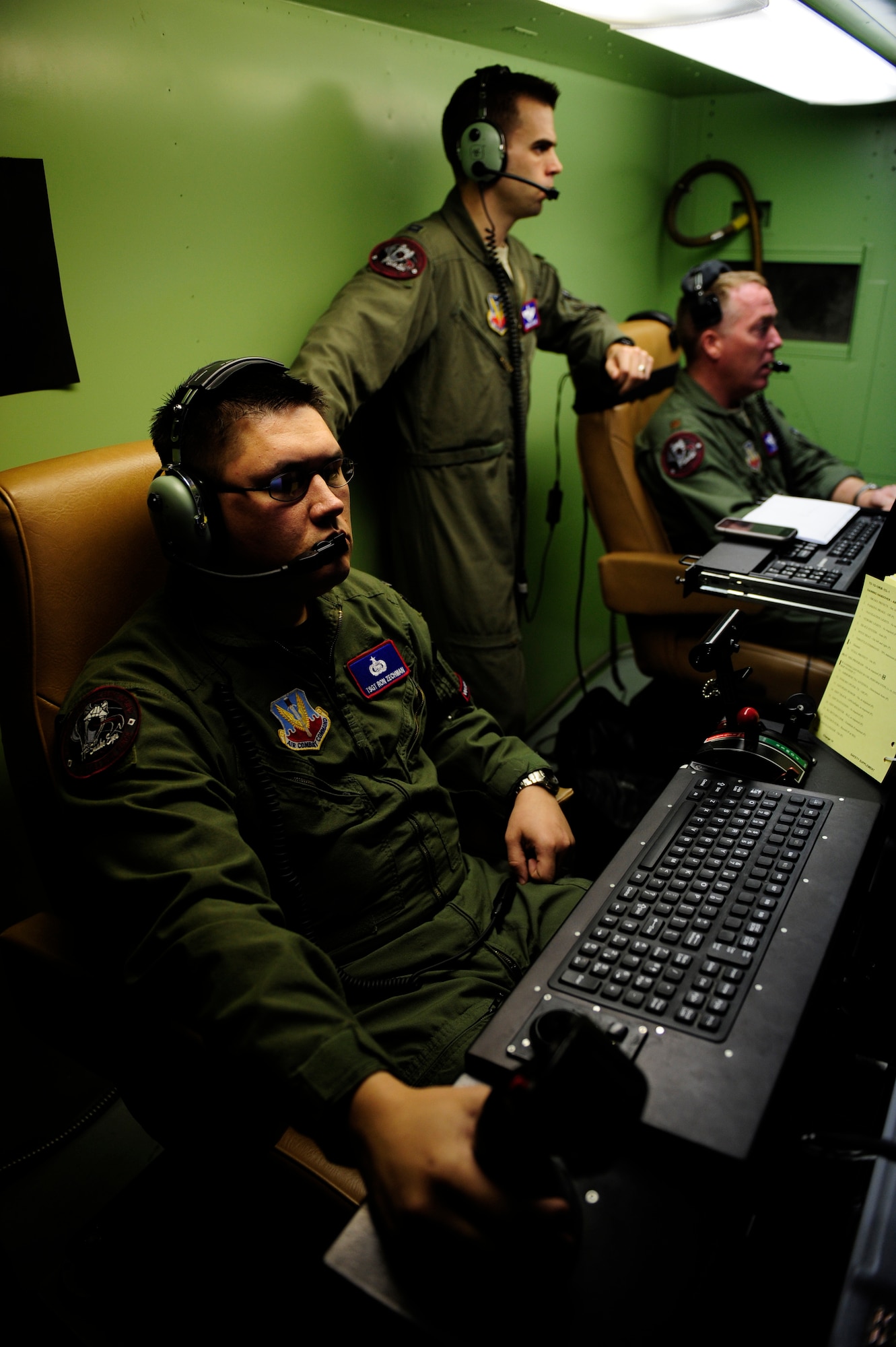 U.S. Air Force Technical Sgt. Ron Zechman, predator sensor operator, and Maj. Jeff Bright, predator pilot and detachment commander, 432nd Wing, Creech Air Force Base, Nevada conduct pre-flight checklists on an RQ-1 Predator at Aeropuerto Rafael Hernandez outside Aguadilla, Puerto Rico on 28 Jan., 2010.  The RQ-1 remotely piloted systems are operating out of Puerto Rico in support of Operation Unified Response in Haiti.  Airmen from Creech Air Force Base, Las Vegas, Nev. are providing 24 hour a day full-motion video in real time to international relief workers on the ground in order to speed humanitarian aid to remote and cut-off areas of the country following the earthquake on 12 Jan., 2010. (U.S. Air Force photo by Tech. Sgt. Jaime Mendez)