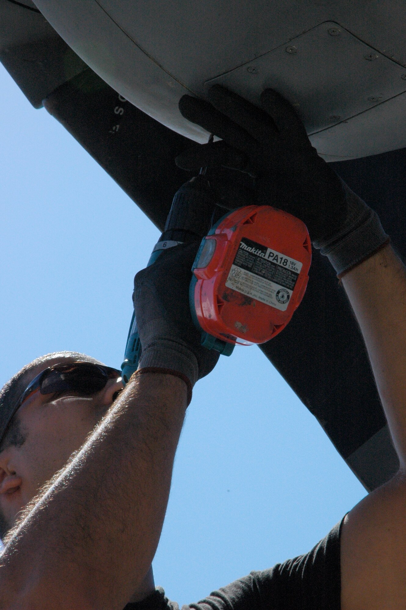 Senior Airman Richard Amador, a C-130 Hercules sheet metal technicians assigned to the Puerto Rico Air National Guard's 156th Airlift Wing, drills out a rivet Jan. 24 while troubleshooting an engine cover issue at Muniz Air Base, Puerto Rico. Both Airman Amador and his co-worker, Staff Sgt. Victor Flores, toiled over the issue several times until the Minnesota ANG aircraft's engine air intake cover was securely fastened back to the aircraft. The aircraft is from one of two airlift wings deployed to Muniz Air Base in support of Air Expeditionary Force Coronet Oak, operated by the 35th Expeditionary Airlift Squadron. (U.S. Air Force photo/Staff Sgt. Stephen J. Collier)