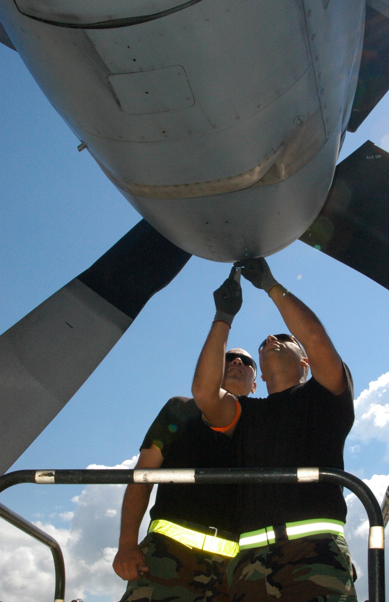 Senior Airman Richard Amador (right) and Staff Sgt. Victor Flores, C-130 Hercules sheet metal technicians assigned to the Puerto Rico Air National Guard's 156th Airlift Wing, troubleshoot an engine cover issue Jan. 24 at Muniz Air Base, Puerto Rico. Both technicians toiled over the issue several times until the Minnesota ANG aircraft's engine air intake cover was securely fastened back to the aircraft. The aircraft is from one of two airlift wings deployed to Muniz Air Base in support of Air Expeditionary Force Coronet Oak, operated by the 35th Expeditionary Airlift Squadron. (U.S. Air Force photo/Staff Sgt. Stephen J. Collier)