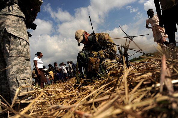 A U.S. Air Force combat controller prepares to contact the special tactics operation center by radio while conducting a drop zone survey in Port-au-Prince, Haiti, Jan. 24, 2010, during Operation Unified Response. (U.S. Air Force photo/Master Sgt. Jeremy Lock) 
