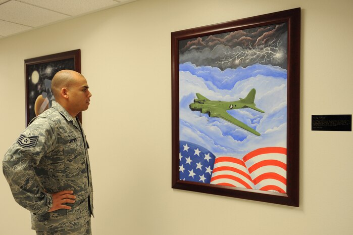 Tech Sgt. Randy James, 57th Maintenance Group quality assurance inspector, admires the 'Flying Fortress' painting in the Airman Leadership School. Sergeant James was asked to create five mural paintings placed on the wall leading to the Heritage Room at the Nellis ALS. 