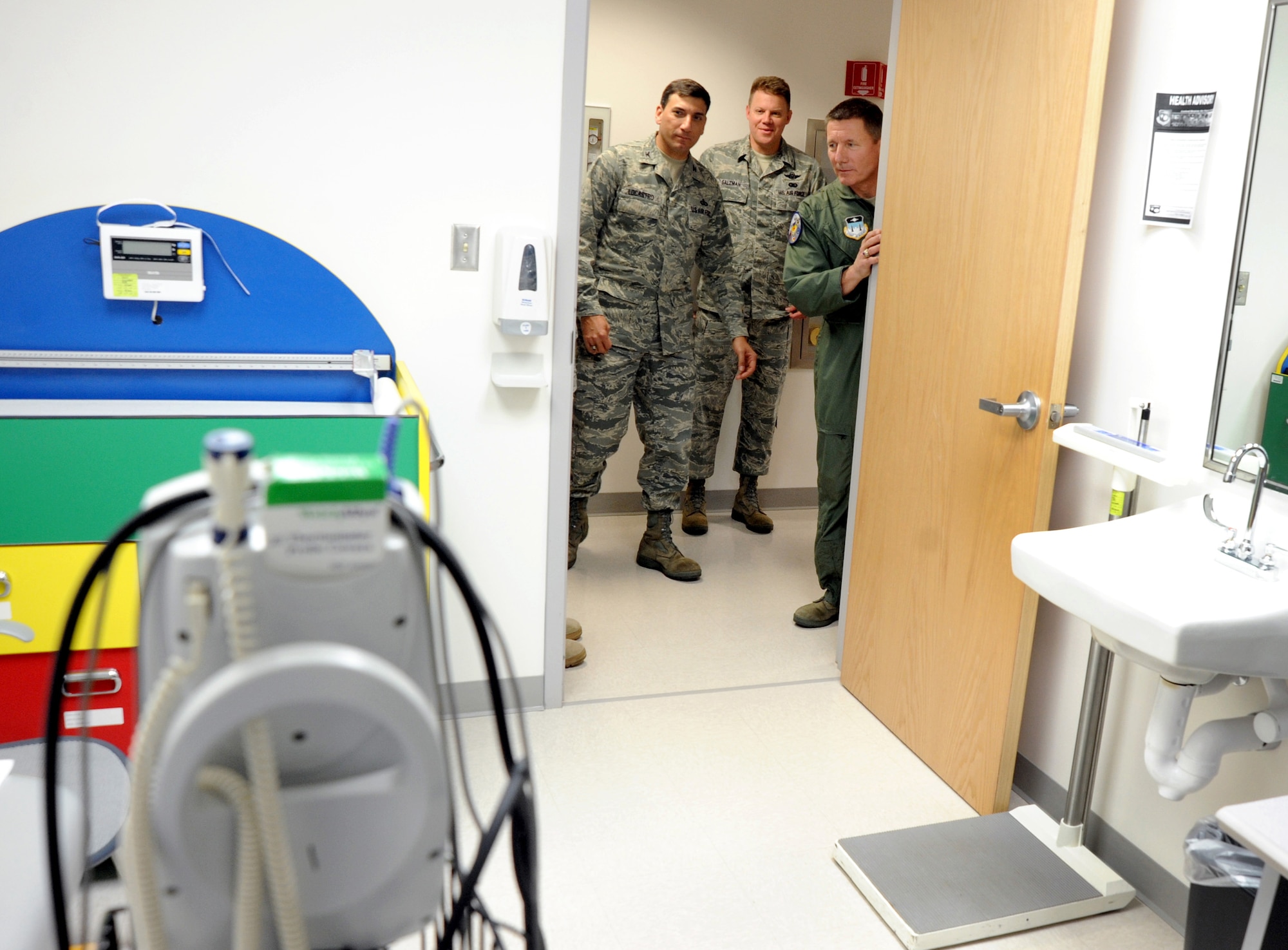 Lt. Gen. Mike Gould (right), Col. Rick LoCastro (left) and Chief Master Sgt. Todd Salzman (center) peek into a newly renovated room in the Academy Clinic Jan. 22. The renovations to 61,000 square feet at the clinic allows the 10th Medical Group to centralize its services and provide better medical care for patients. General Gould is the Academy superintendent; Colonel LoCastro is the 10th Air Base Wing commander, and Chief Salzman is the Academy command chief master sergeant. (U.S. Air Force photo/Johnny Wilson)