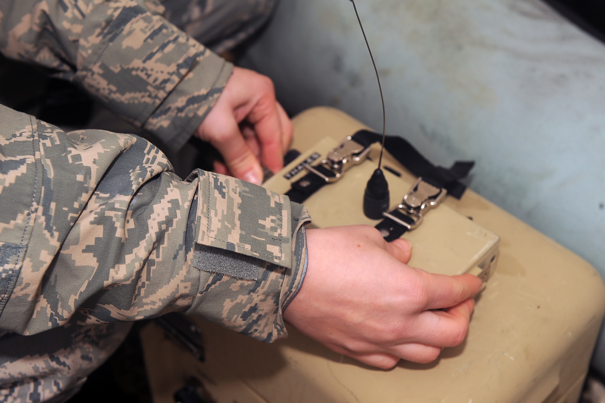 Airman 1st Class Danielle Bushek, 4th Security Forces Squadron patrolman, connects a communication module to a rechargeable battery during an electronic security system exercise on Seymour Johnson Air Force Base, N.C., Jan. 22, 2010. When the communication module detects an intruder it sends a signal to the base defense operation center. Bushek hails from Norwich, Conn. (U.S. Air Force photo/Senior Airman Ciara Wymbs) 