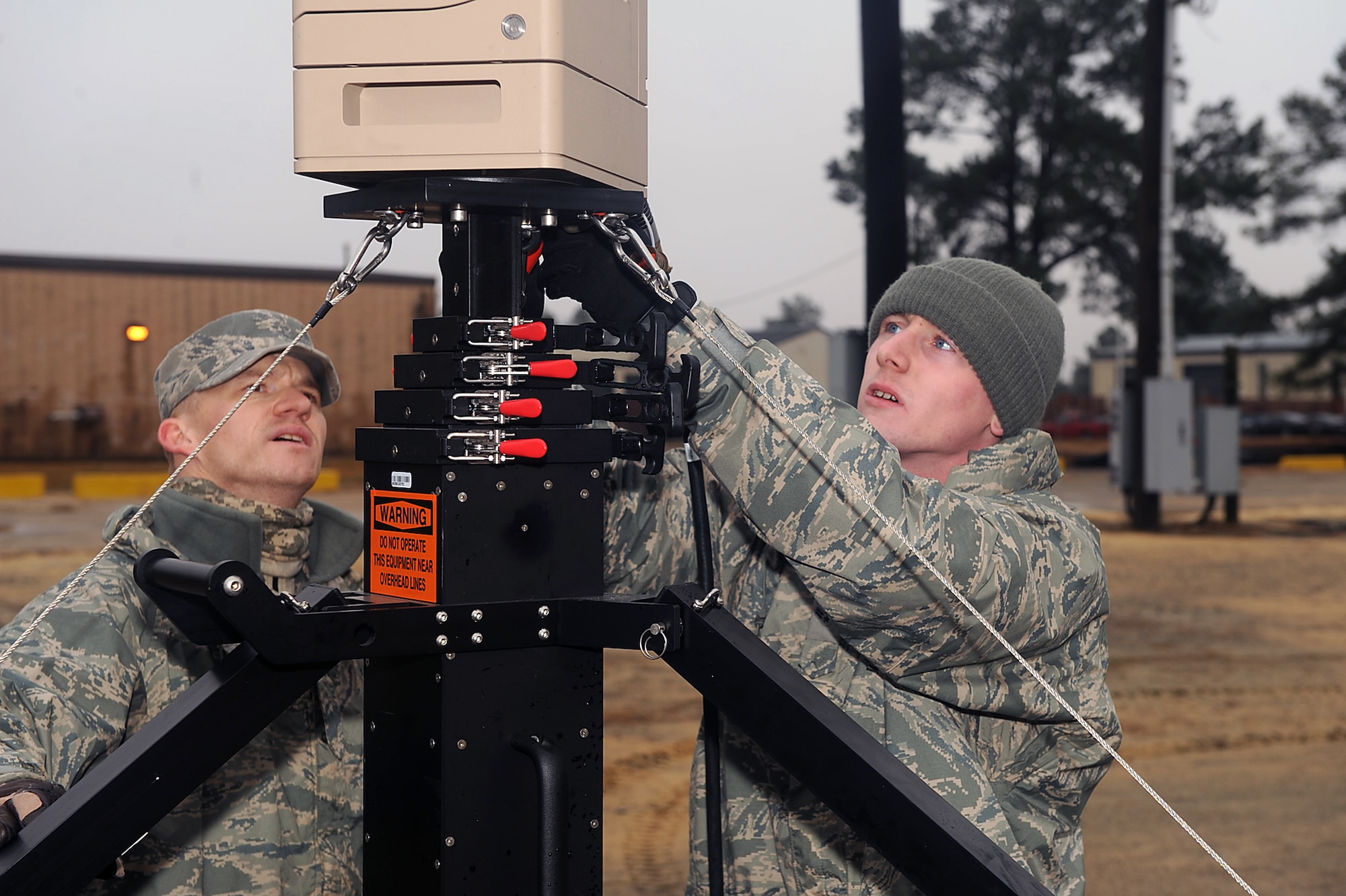 Airmen 1st Class Cameron Welsh and Jason Caywood, both 4th Security Forces Squadron patrolmen, set-up a wide area surveillance monitor during an electronic security system exercise on Seymour Johnson Air Force Base, N.C., Jan. 22, 2010. When used to maintain a secure perimeter, the monitor captures thermal imaging if there is an intruder within the area being monitored.  Welsh is from Galion, Ohio, and Caywood is from Woodward, Okla. (U.S. Air Force photo/Senior Airman Ciara Wymbs)   