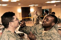 Master Sgt. Jesse Renteria receives the H1N1 flu mist inoculation from Staff Sgt. Vashon Bynum during a point of distribution exercise Jan. 21, 2010, at Offutt Air Force Base, Neb.  Sergeant Renteria is assigned to the 55th Maintenance Operations Squadron and Sergeant Bynum is assigned to the 55th Medical Group. (U.S. Air Force photo/Charles Haymond)