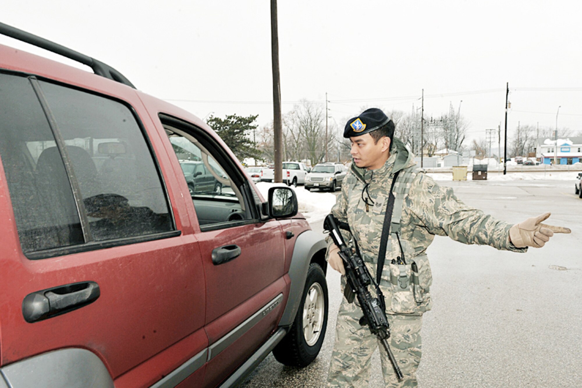 Staff Sgt. Ernie Argarin directs a driver at an entry control point near the community center here during a point of distribution exercise Jan. 21, 2010, at Offutt Air Force Base, Neb. Sergeant Argarin is assigned to the 55th Security Forces Squadron. (U.S. Air Force photo/Charles Haymond)