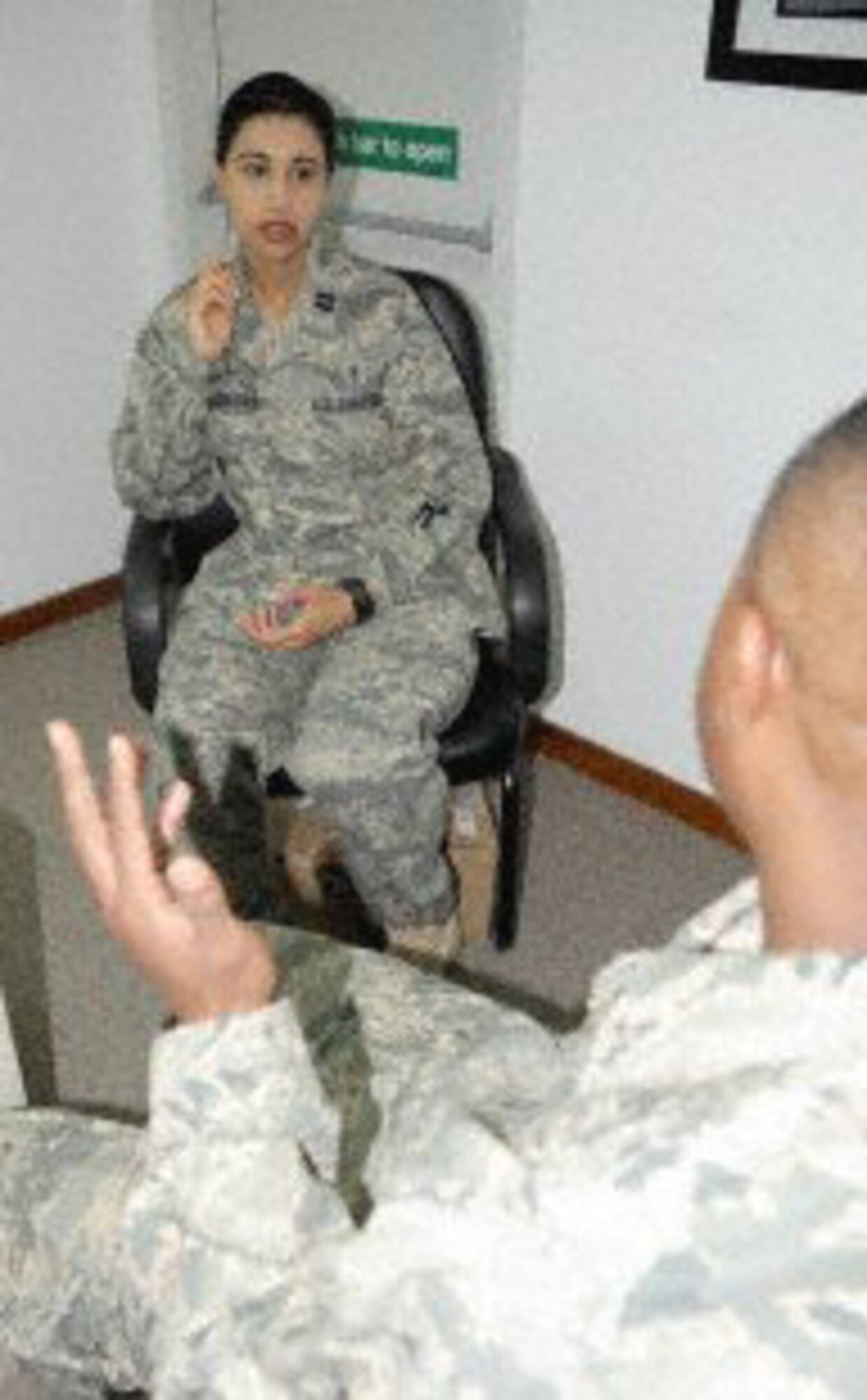 Capt. (Dr.) Kieran Dhillon-Davis, 380th Expeditionary Medical Group mental health chief and clinical psychologist, talks with an Airman Jan. 22, 2010, during operations at an air base in Southwest Asia. She is deployed from the 82nd Medical Operations Squadron at Sheppard Air Force Base, Texas. (U.S. Air Force photo)